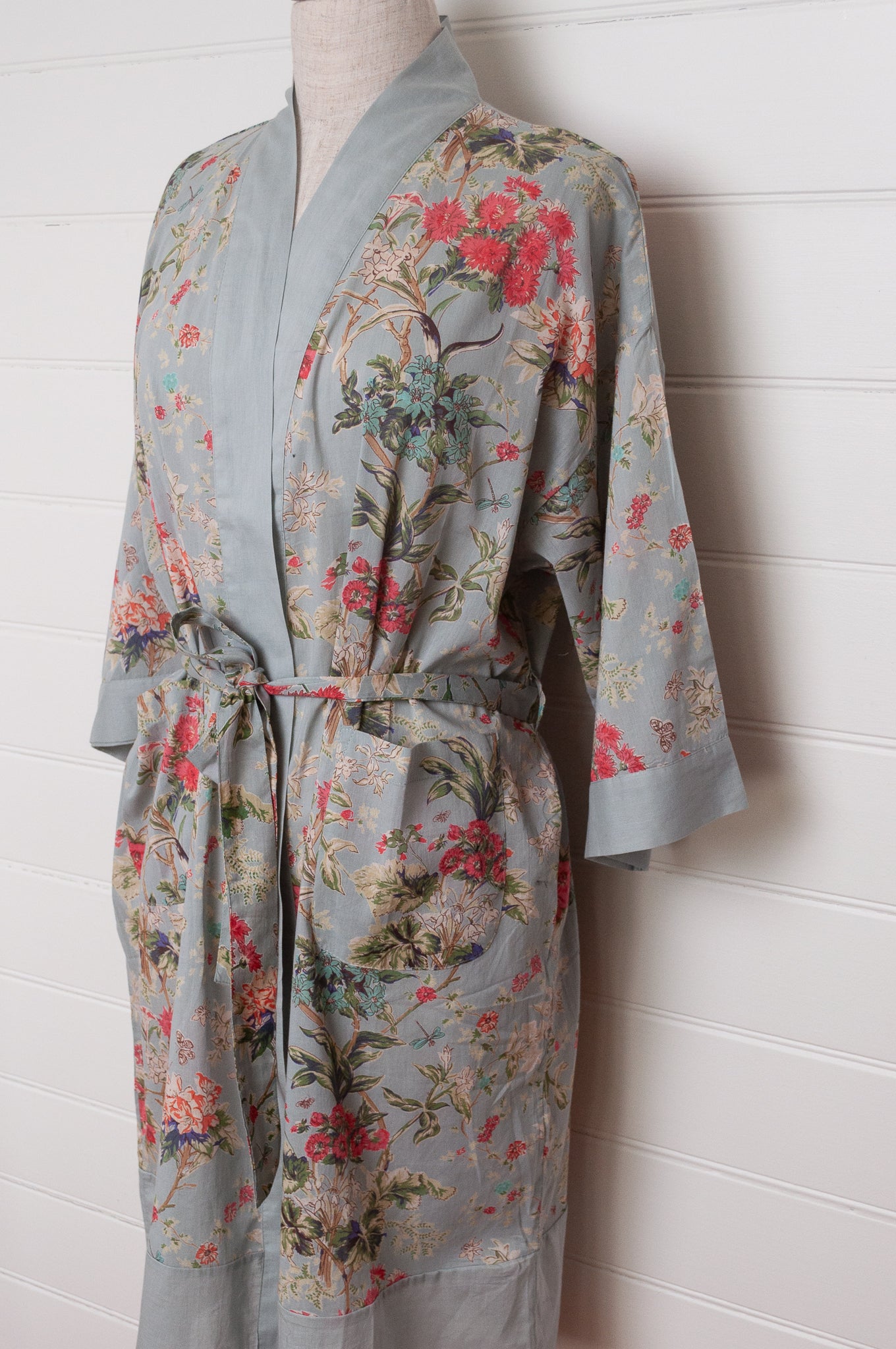 Juniper Hearth cotton voile kimono in country garden print, pink and vanilla flowers on duck egg blue background.