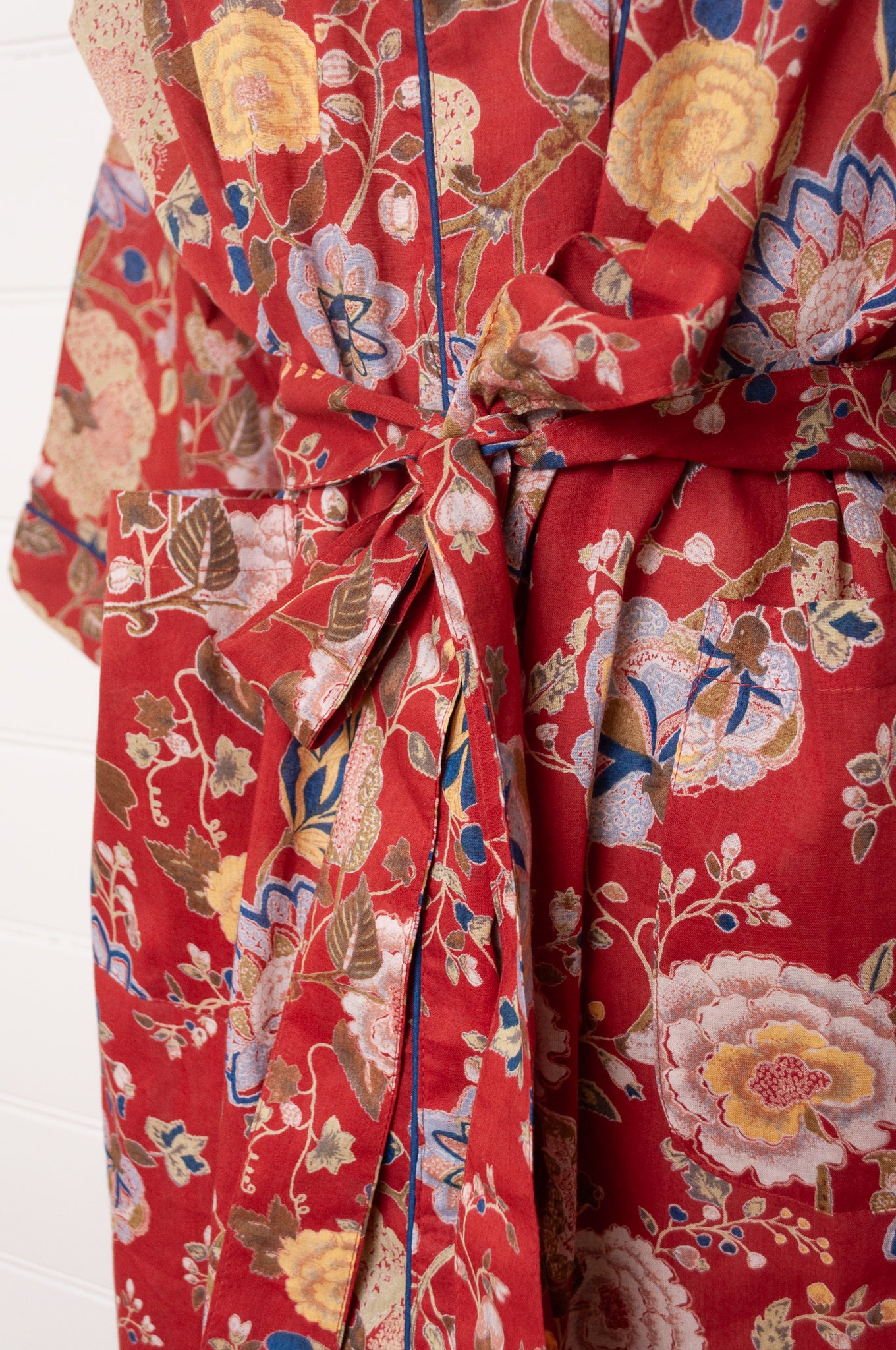 Juniper Hearth kimono in Malabar rust gold and cream and denim blue flowers on rust red background.