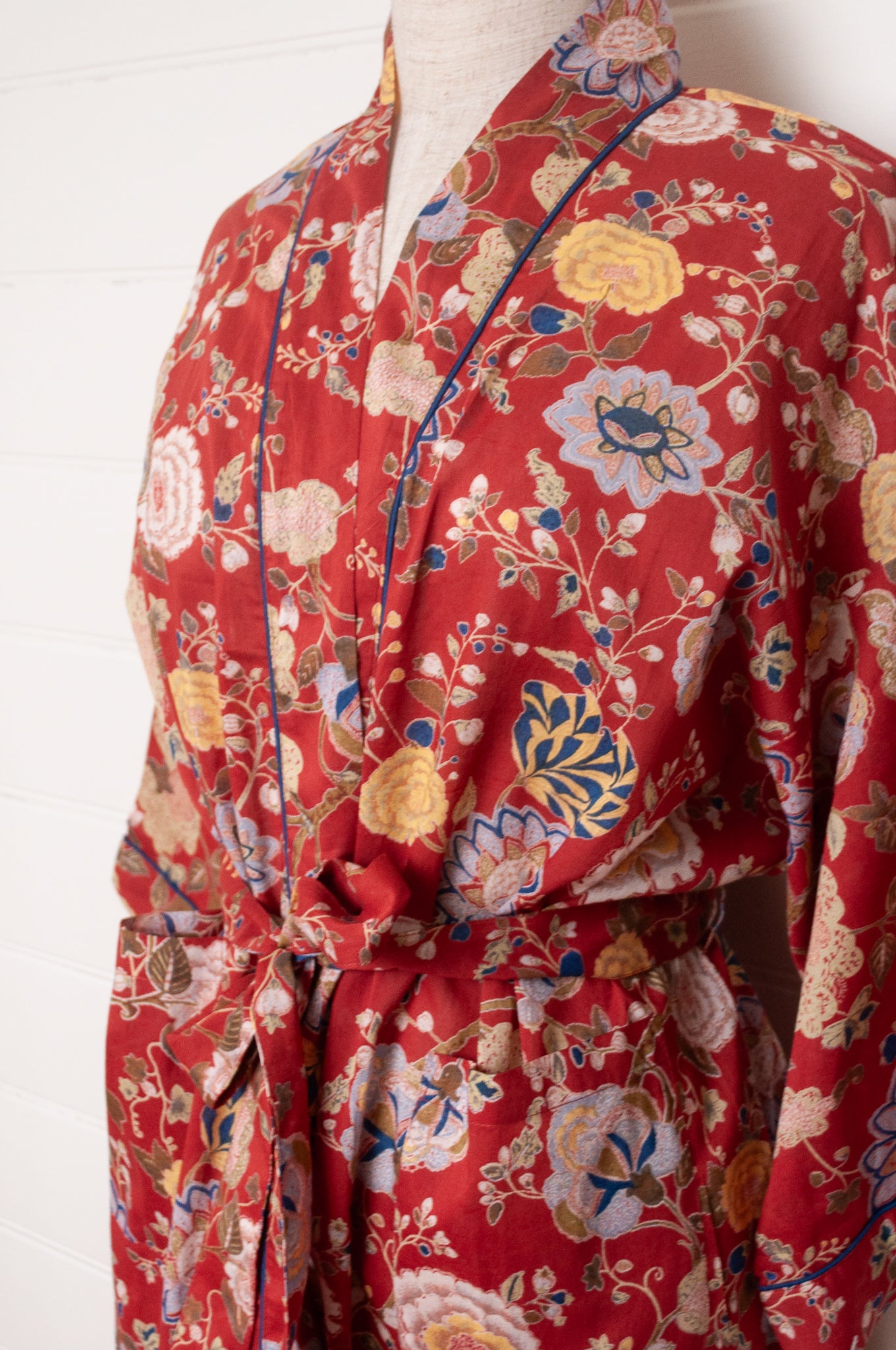 Juniper Hearth kimono in Malabar rust gold and cream and denim blue flowers on rust red background.