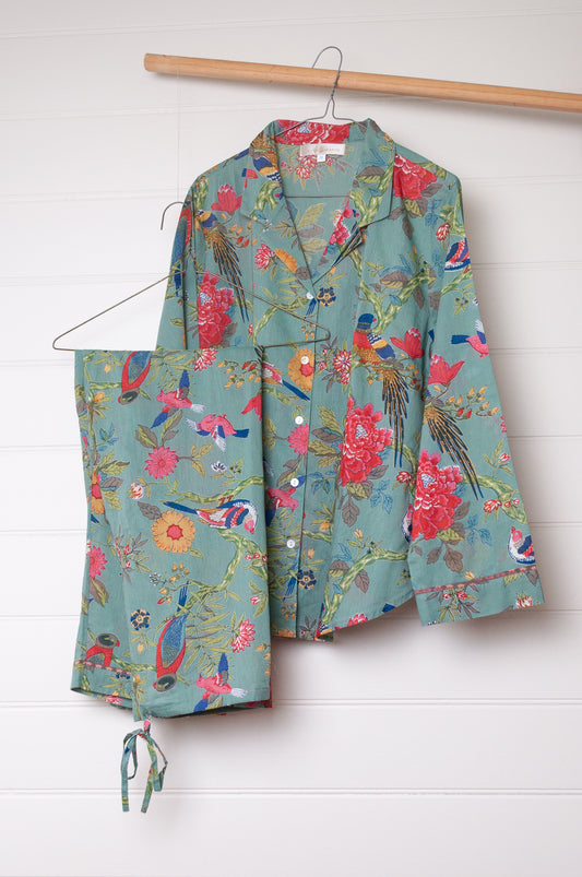 Juniper Hearth cotton voile pyjamas, screen printed with vibrant floral print on aqua blue background.