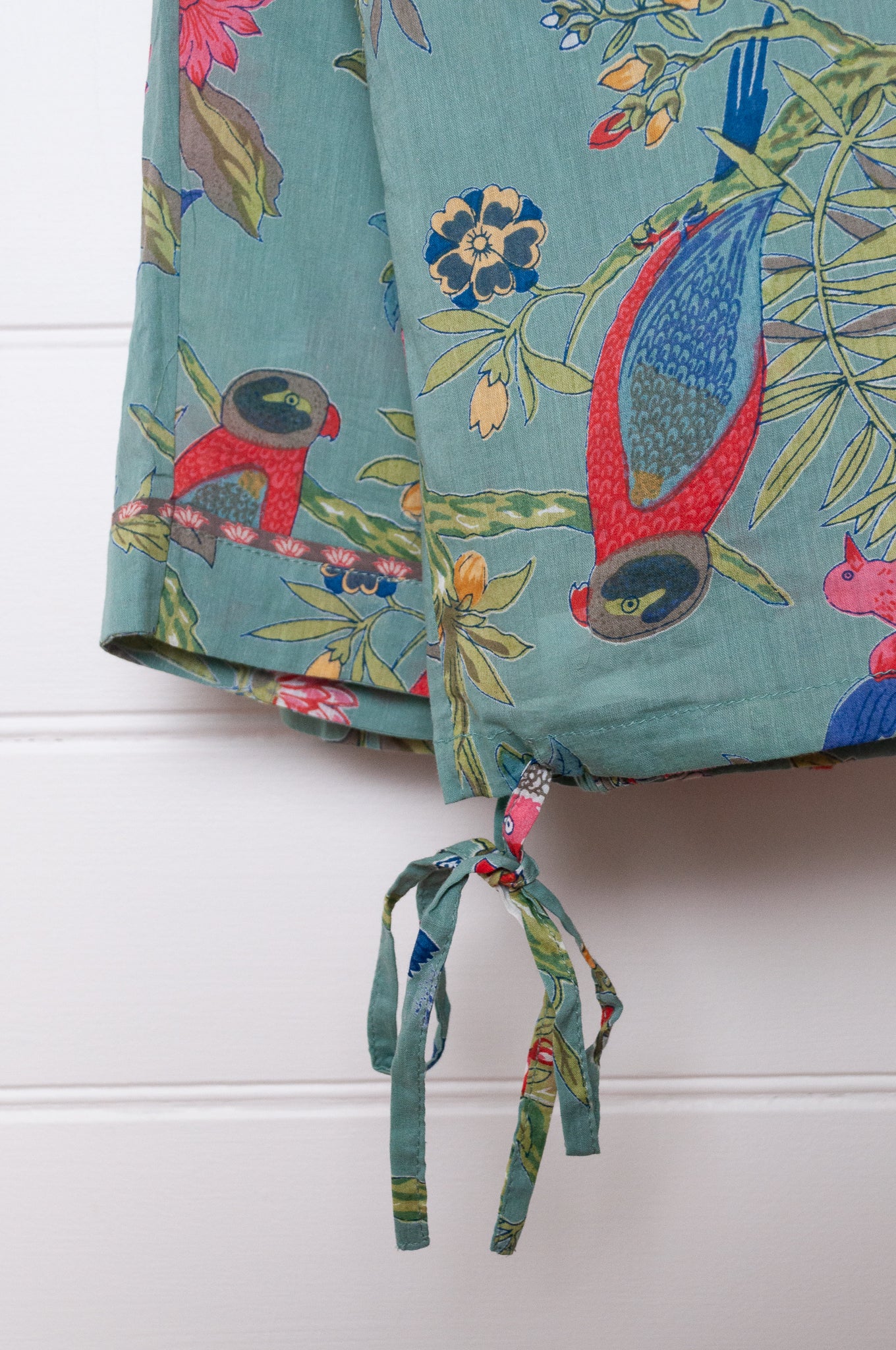 Juniper Hearth cotton voile pyjamas, screen printed with vibrant floral print on aqua blue background.