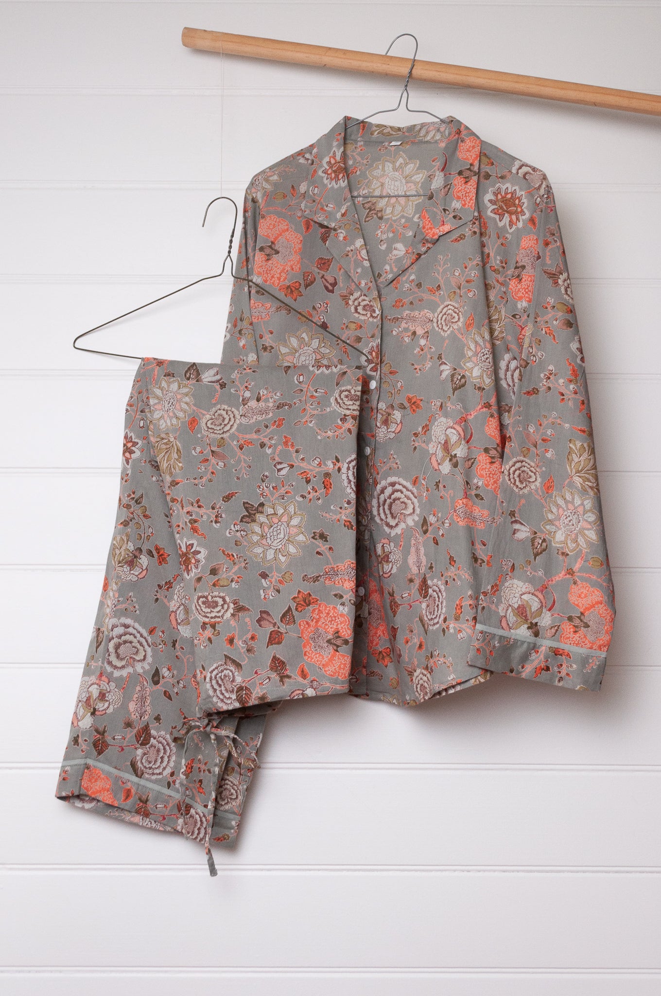 Juniper Hearth cotton voile pyjamas, screen printed with floral print on sage green background.