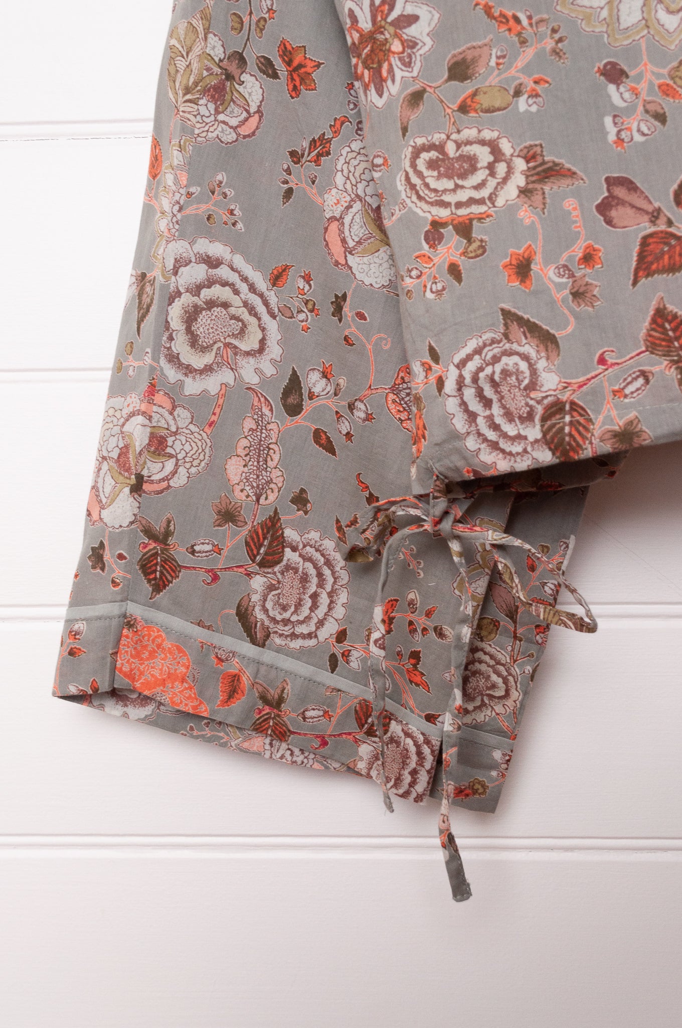 Juniper Hearth cotton voile pyjamas, screen printed with floral print on sage green background.