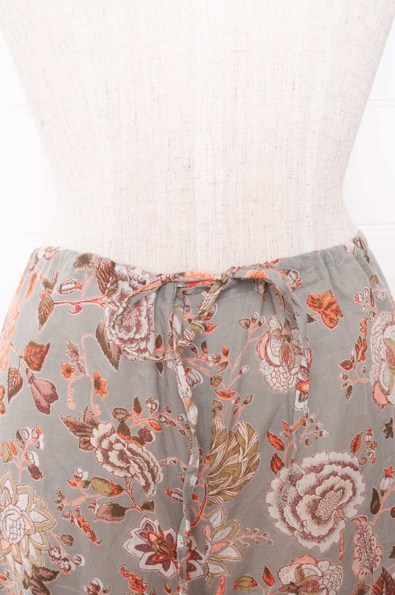 Juniper Hearth cotton voile pyjamas, screen printed with floral print on sage green background.