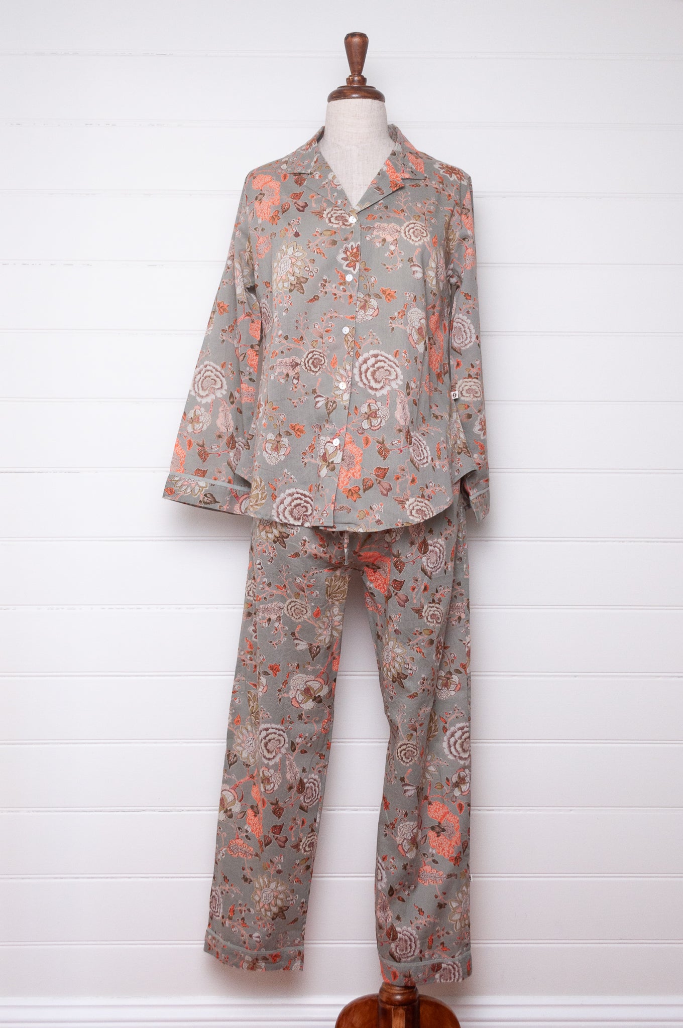 Juniper Hearth cotton voile pyjamas, screen printed with floral print on sage green background.