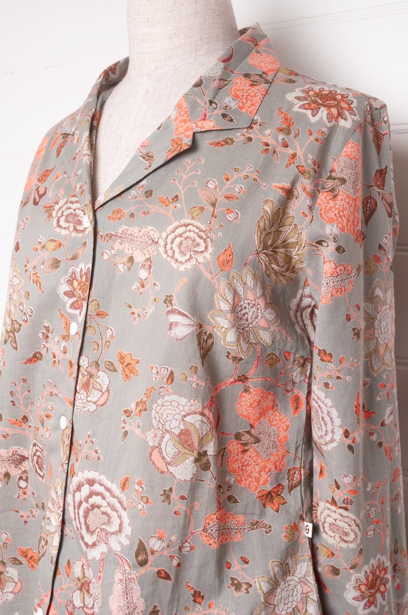 Juniper Hearth cotton voile pyjamas, screen printed with floral print on sage green background.