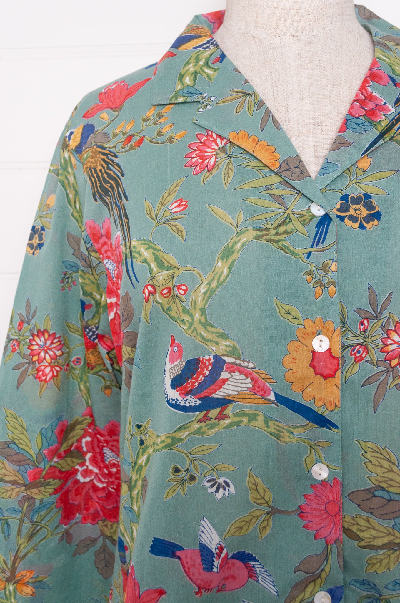 Juniper Hearth cotton voile pyjamas, screen printed with vibrant floral print on aqua blue background.