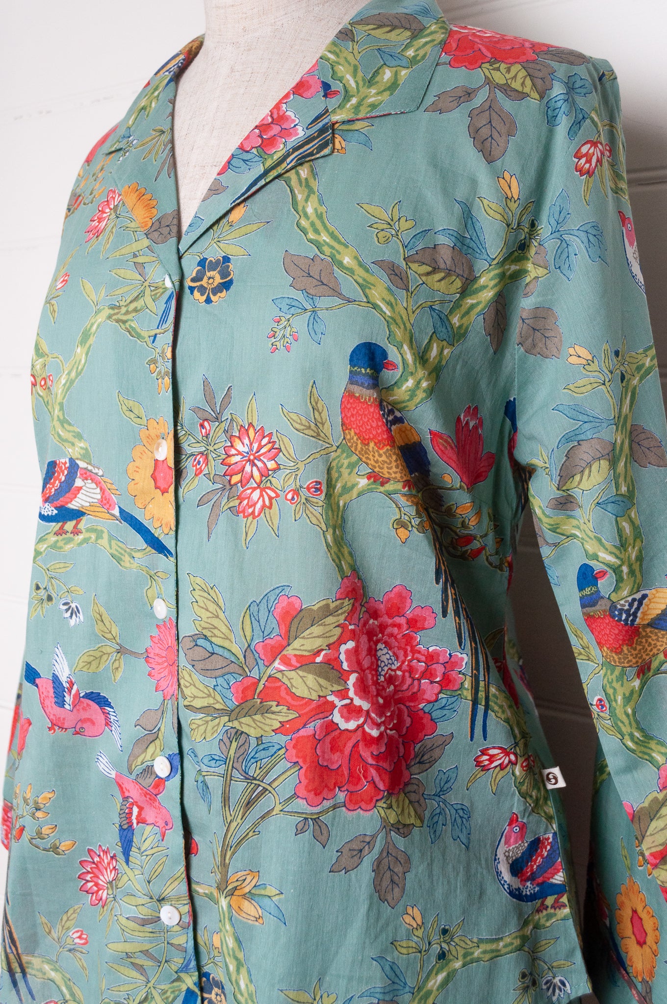 Juniper Hearth cotton voile pyjamas, screen printed with vibrant floral print on aqua blue background.