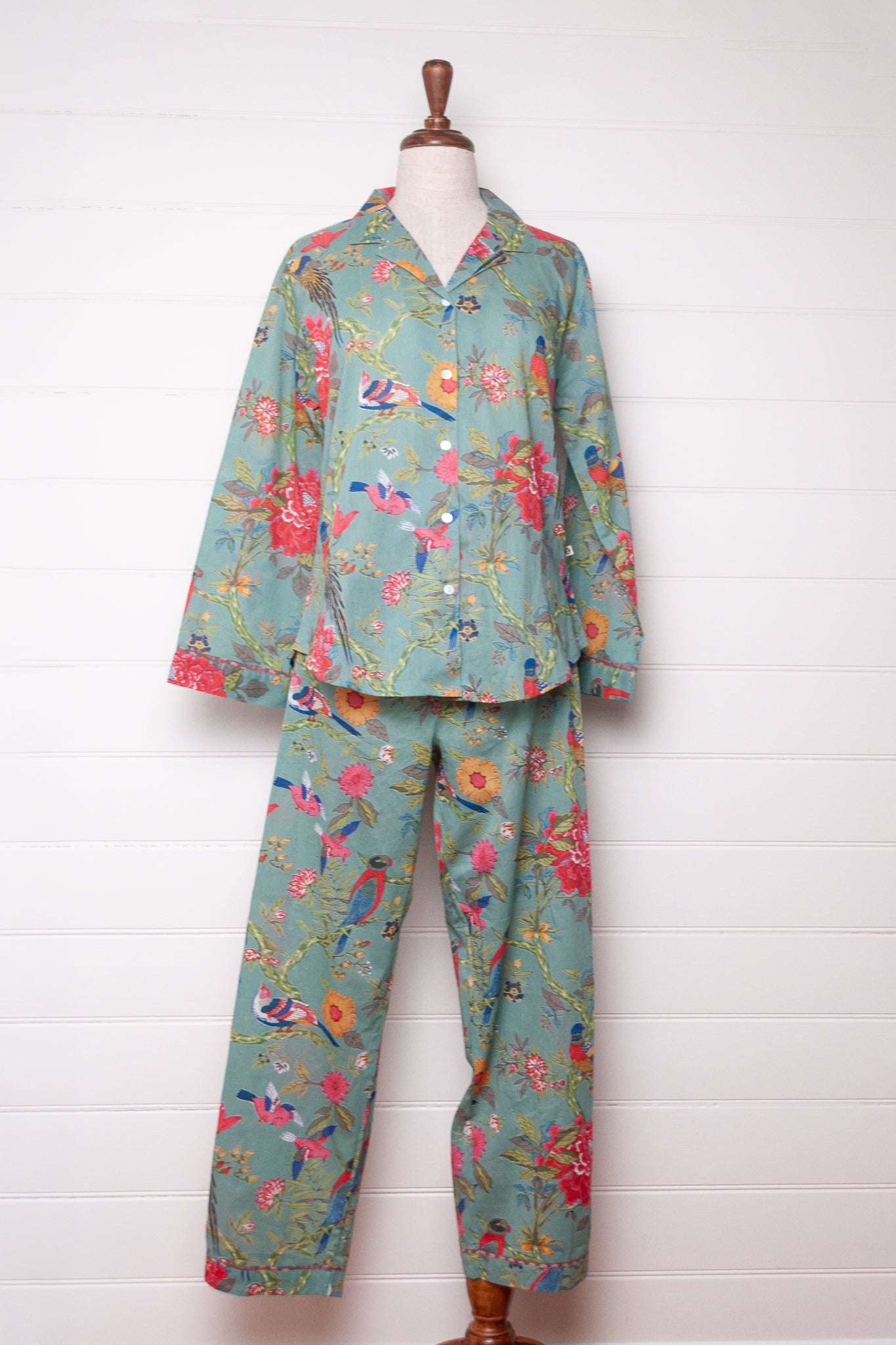 Juniper Hearth cotton voile pyjamas, screen printed with vibrant floral print on aqua blue background.