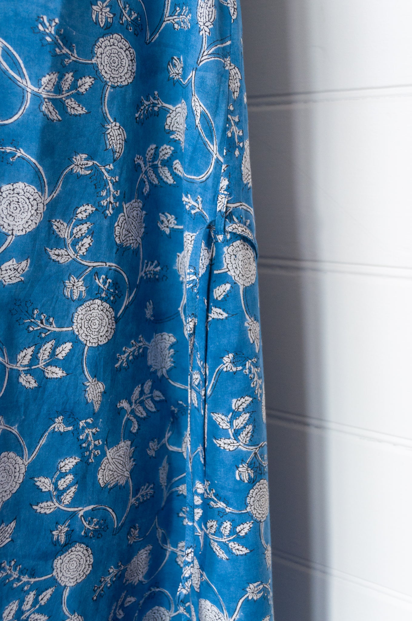 Juniper Hearth Zoe blockprint floral sleeveless cotton dress, buttonup with waist tie, in blue and white.