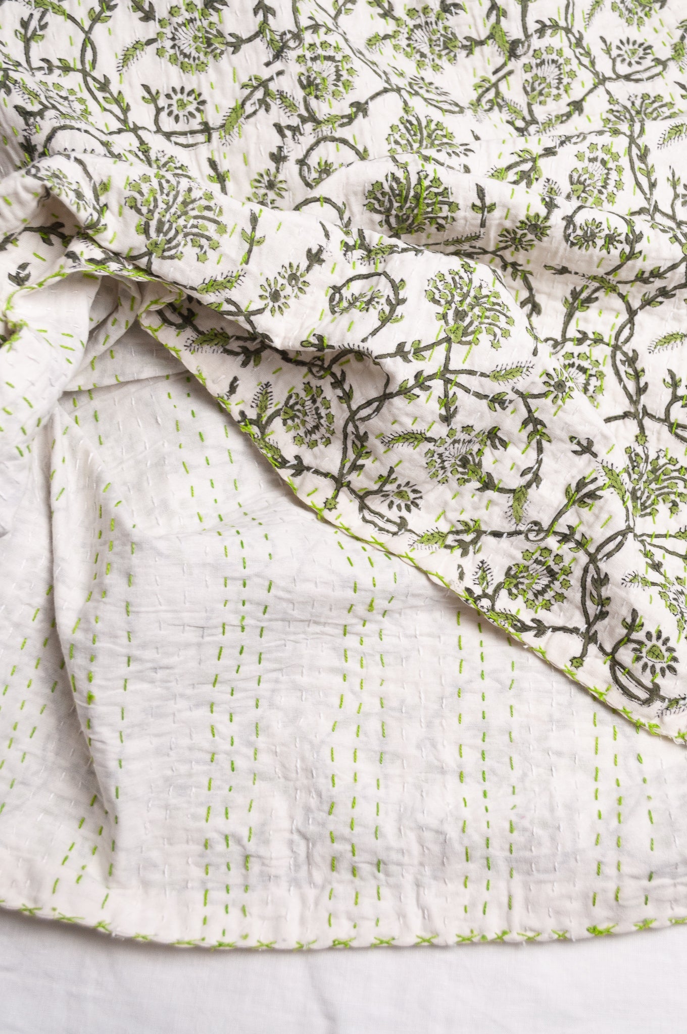 Hand stitched block print pure cotton kantha quilt sage green floral and vine on white.