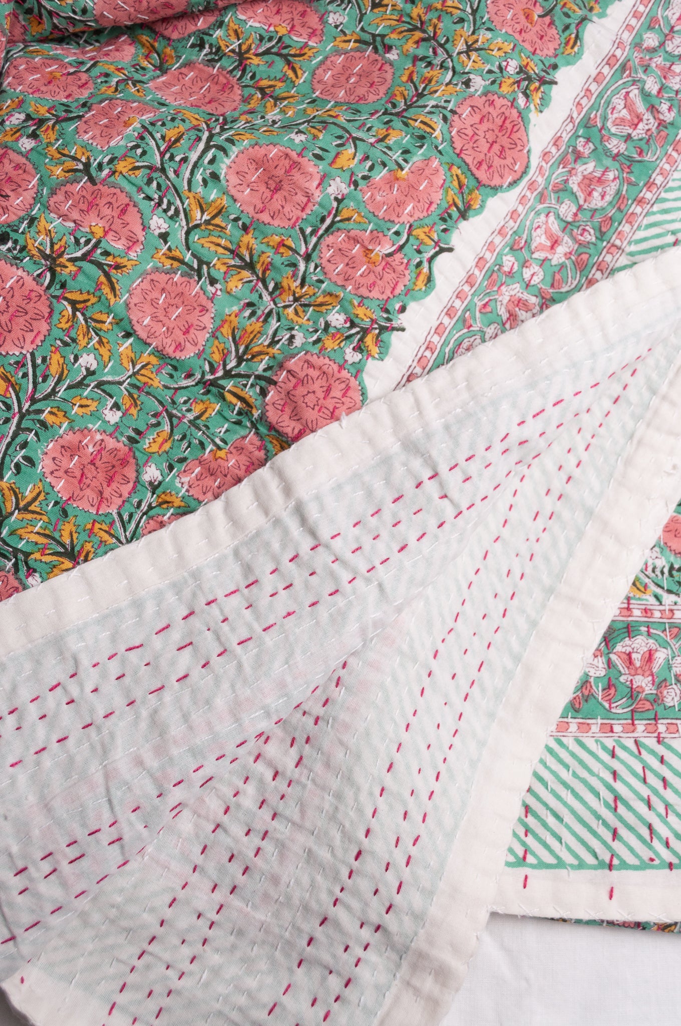 Hand stitched block print pure cotton kantha quilt pink and yellow floral on mint green.