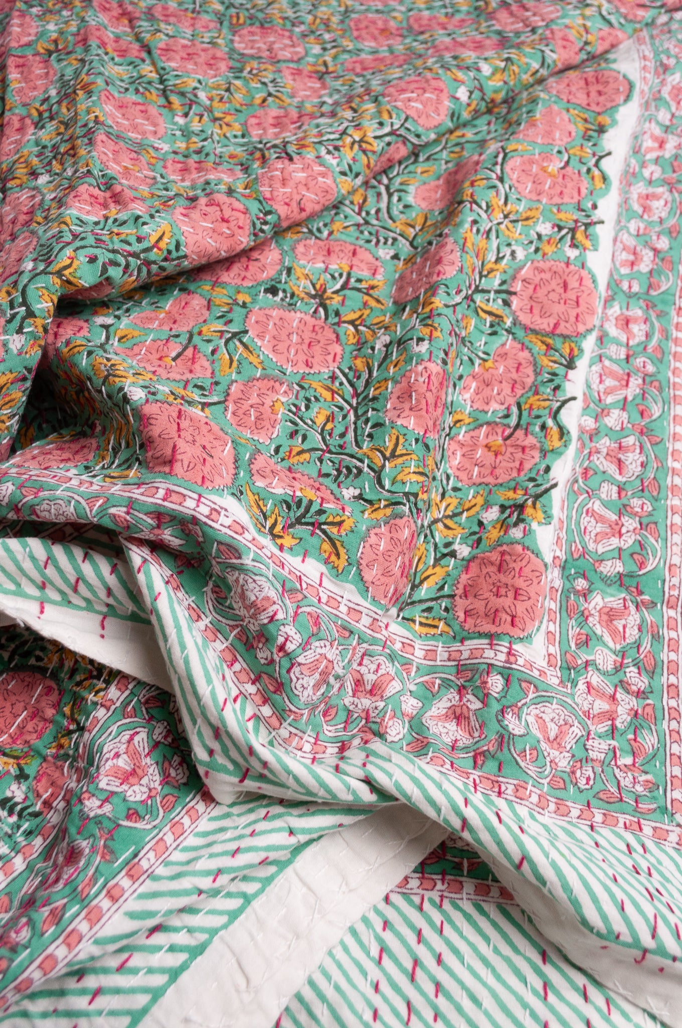 Hand stitched block print pure cotton kantha quilt pink and yellow floral on mint green.