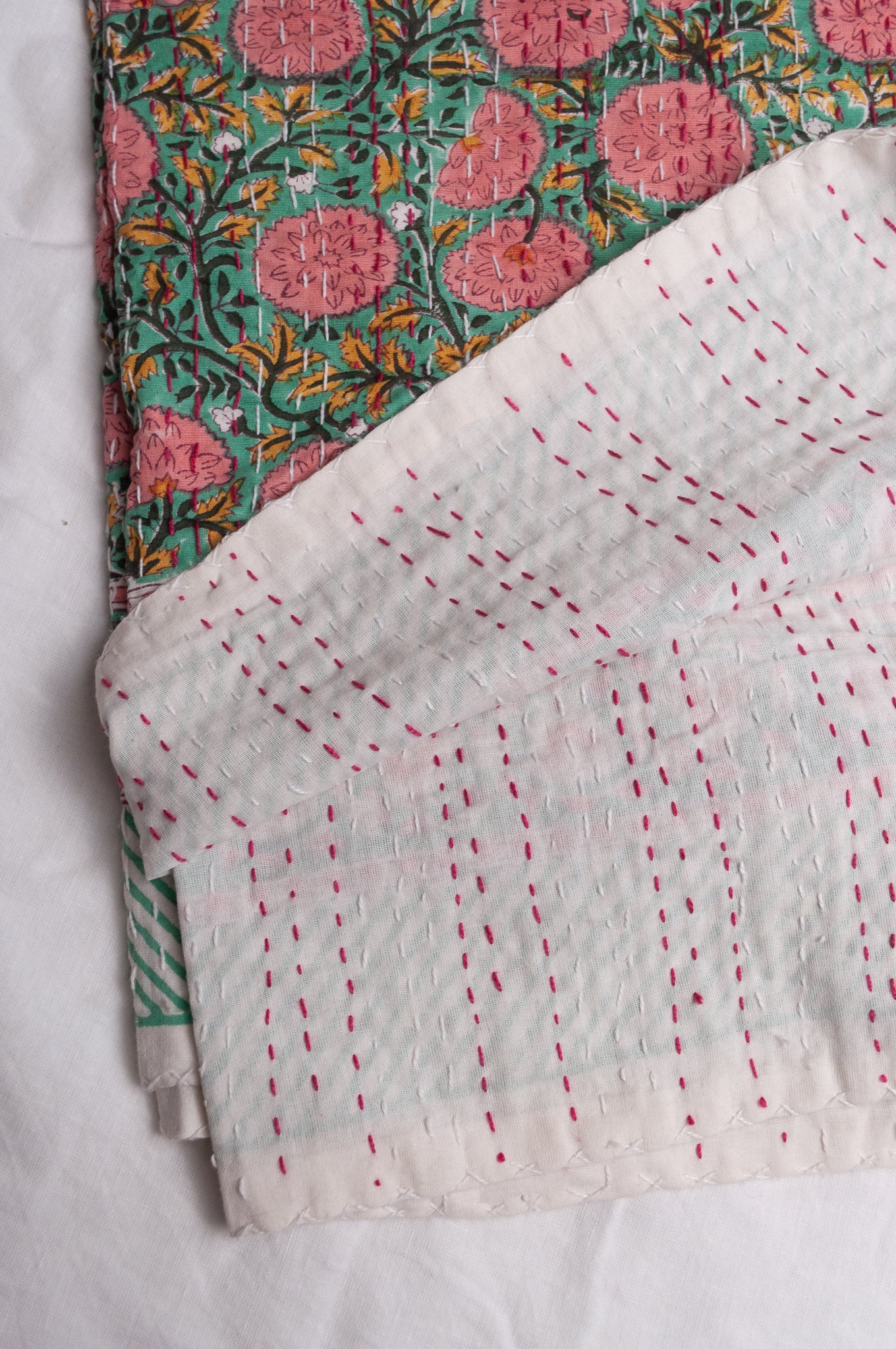 Hand stitched block print pure cotton kantha quilt pink and yellow floral on mint green.