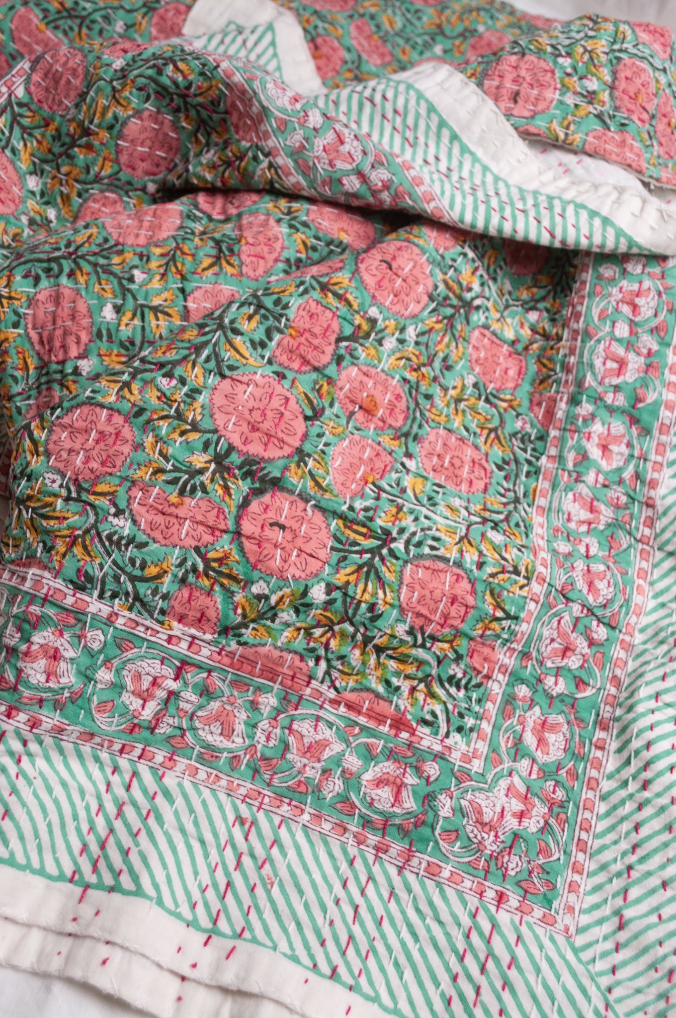 Hand stitched block print pure cotton kantha quilt pink and yellow floral on mint green.