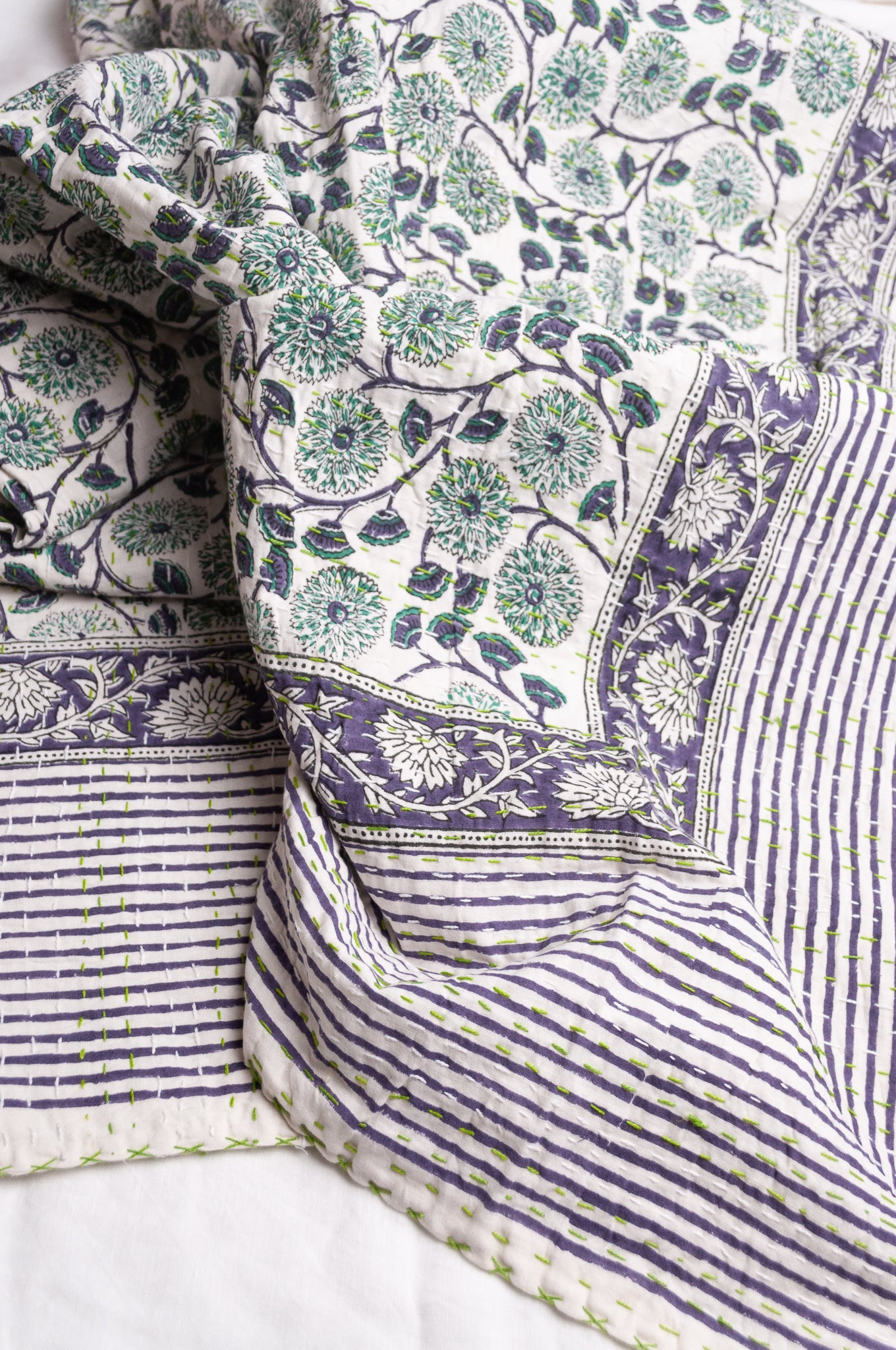 Hand stitched block print pure cotton kantha quilt mint green and indigo blue floral and vine on white.