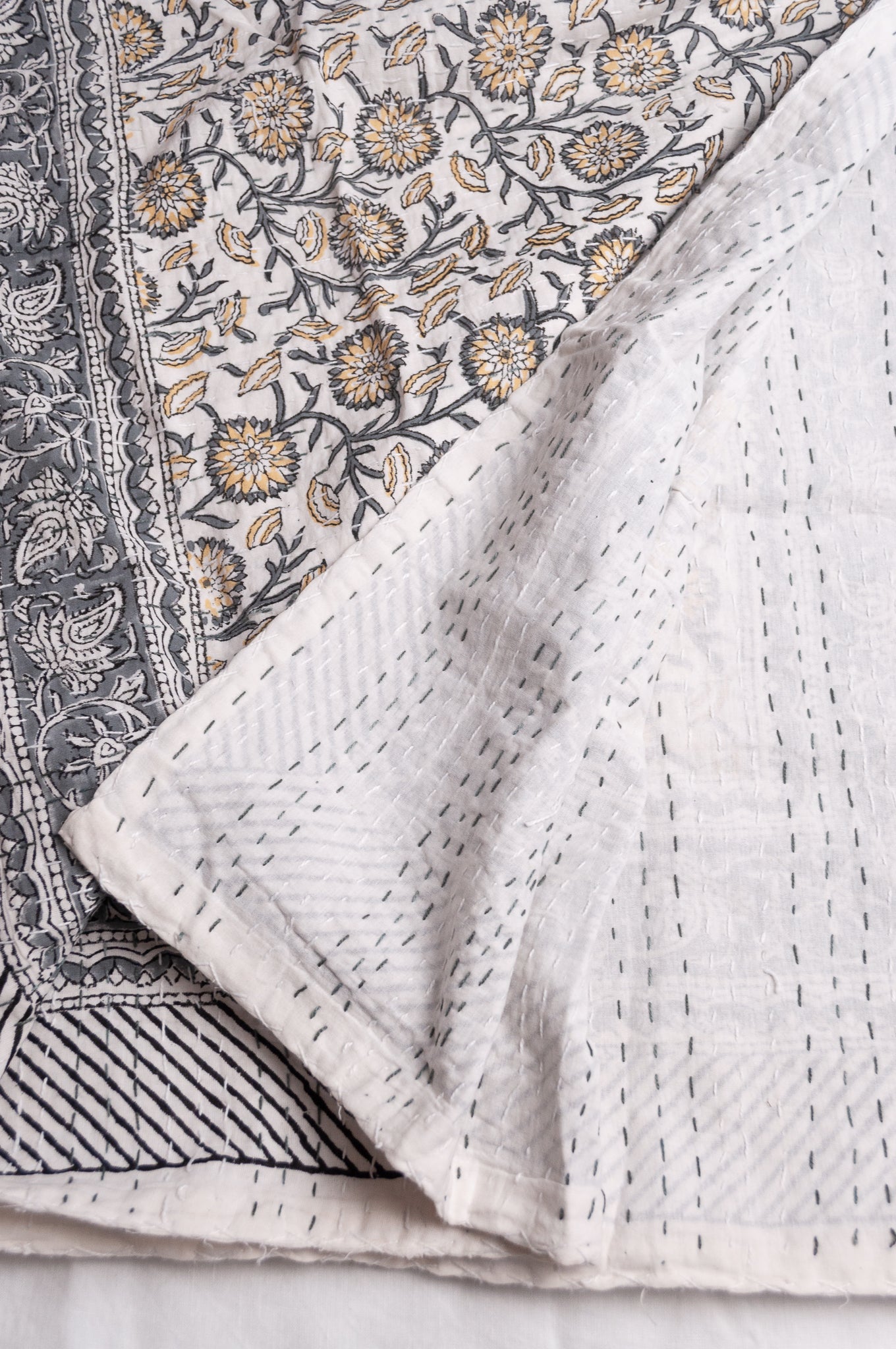 Hand stitched block print pure cotton kantha quilt silver grey and mustard gold floral and vine on white.