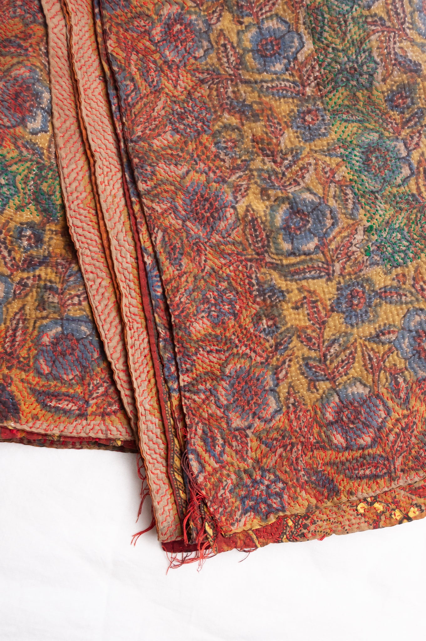 Bagru overdye blockprint vintage kantha quilt in rust red and denim blue on mustard and olive.
