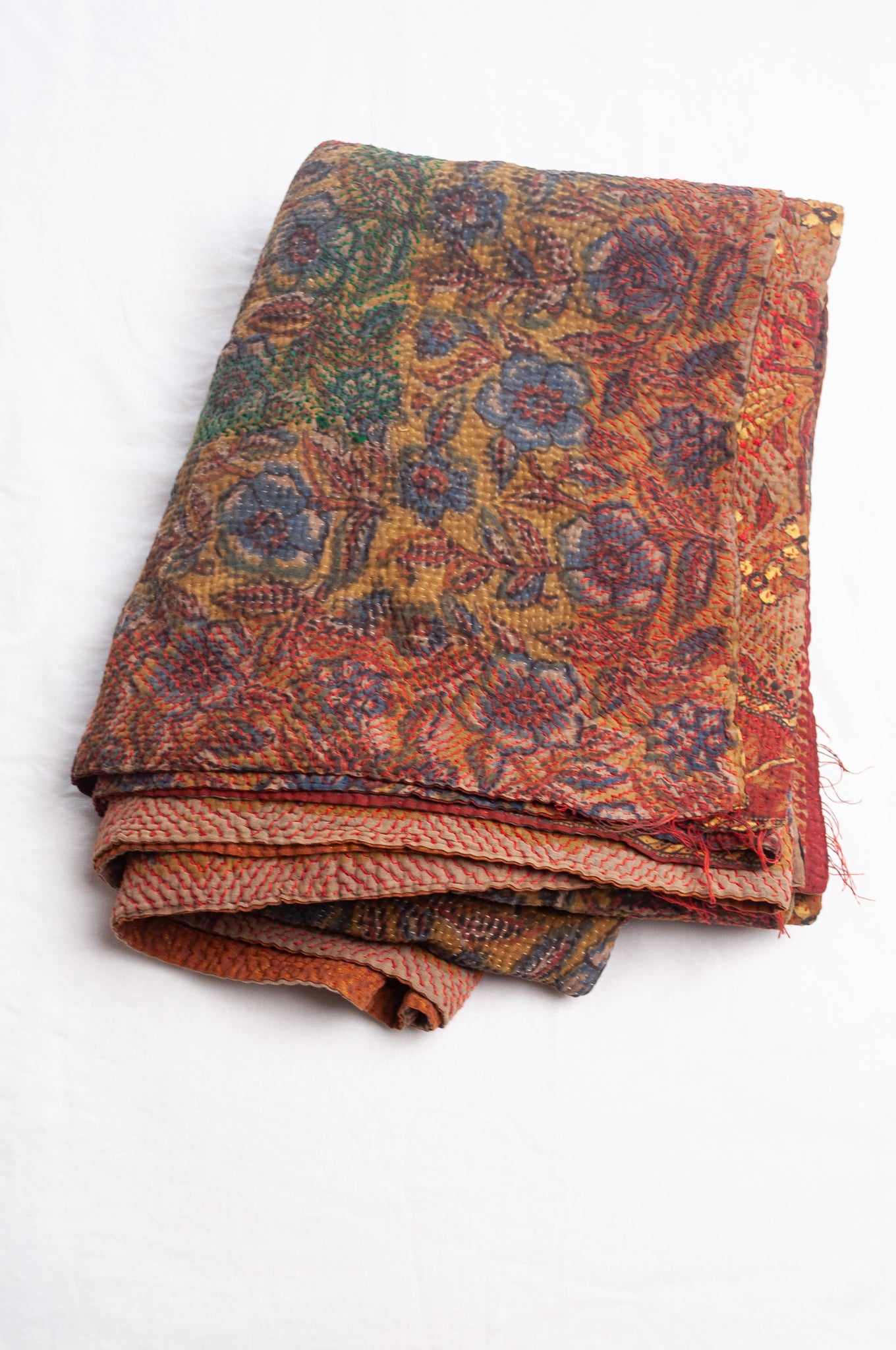 Bagru overdye blockprint vintage kantha quilt in rust red and denim blue on mustard and olive.