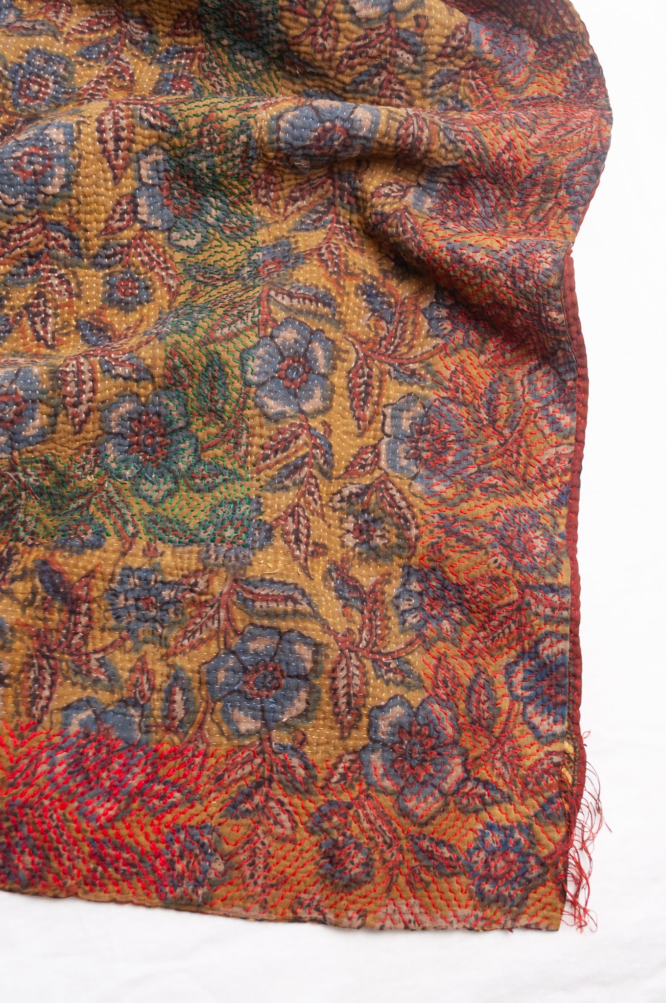 Bagru overdye blockprint vintage kantha quilt in rust red and denim blue on mustard and olive.