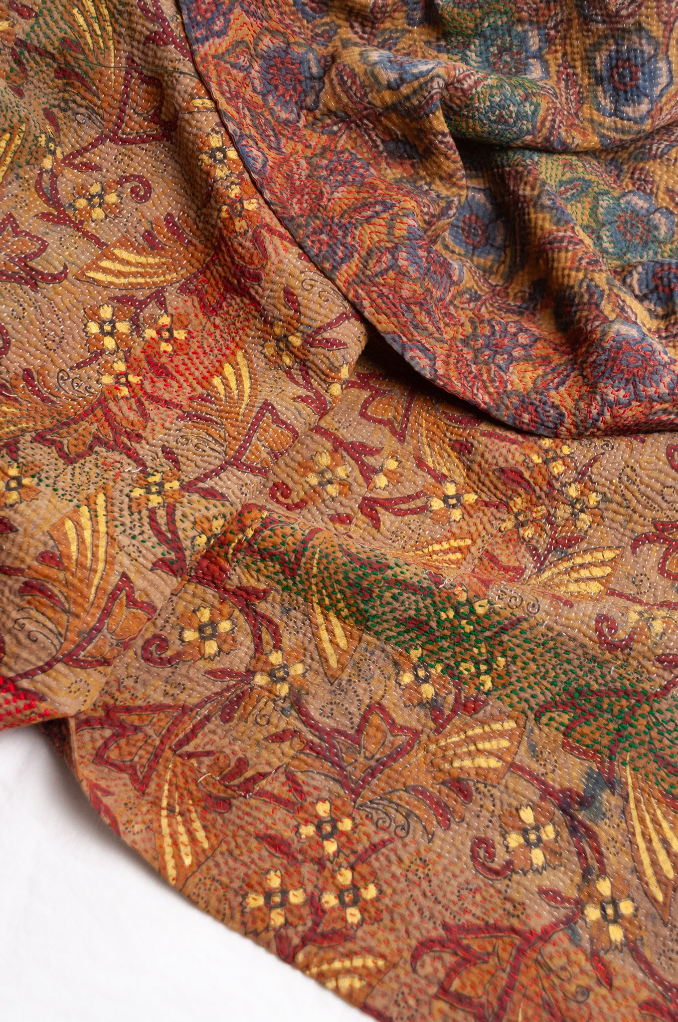 Bagru overdye blockprint vintage kantha quilt in rust red and denim blue on mustard and olive.