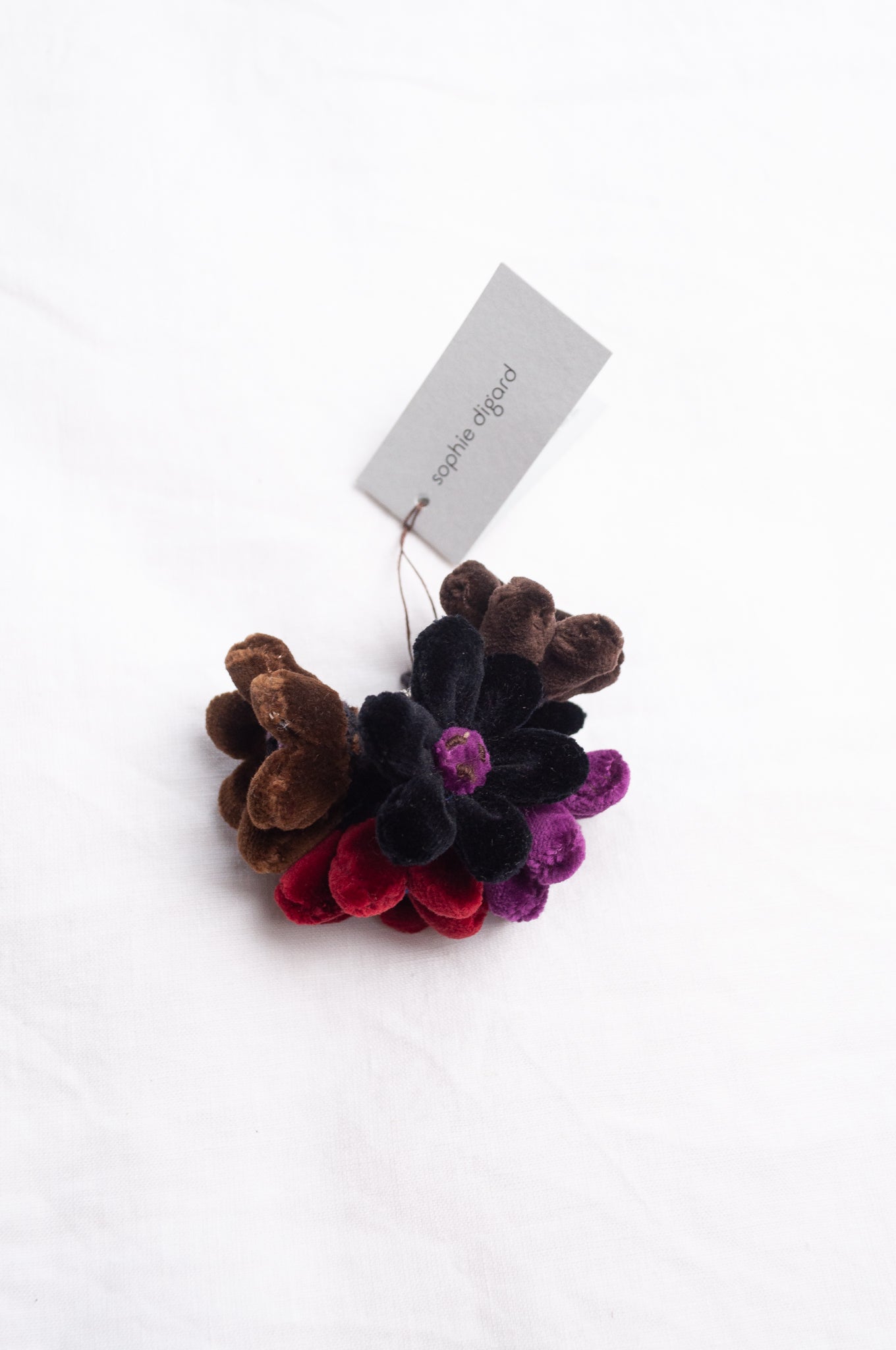 Sophie Digard velour flower jonquille brooch in deep wintery tones.