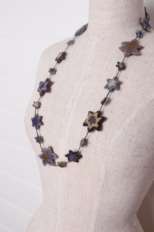 Sophie Digard etoile star crocheted linen necklace in deep shades of navy and browns.