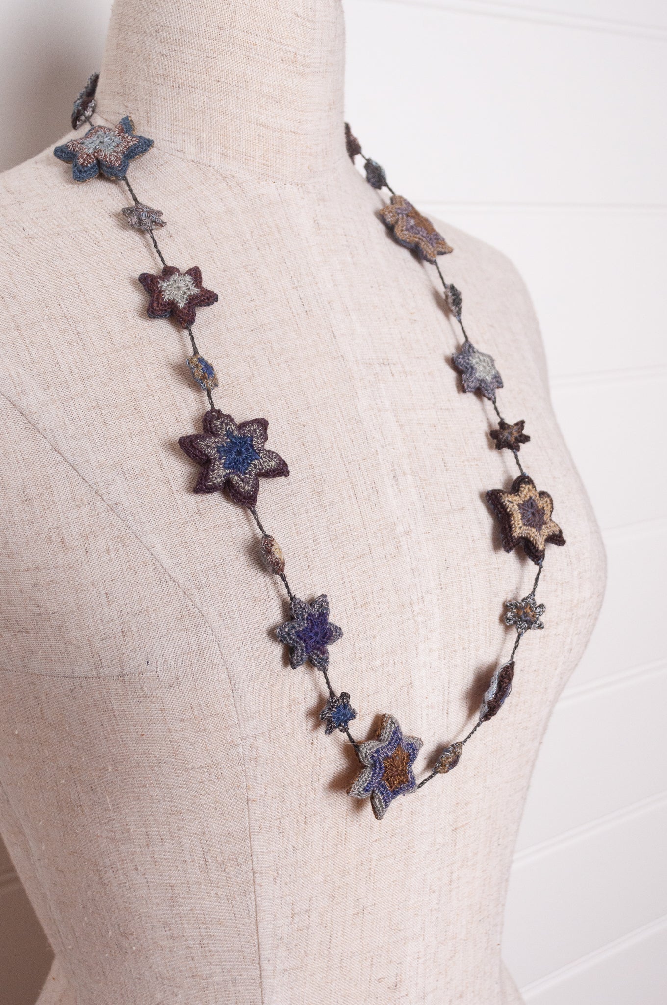 Sophie Digard etoile star crocheted linen necklace in deep shades of navy and browns.