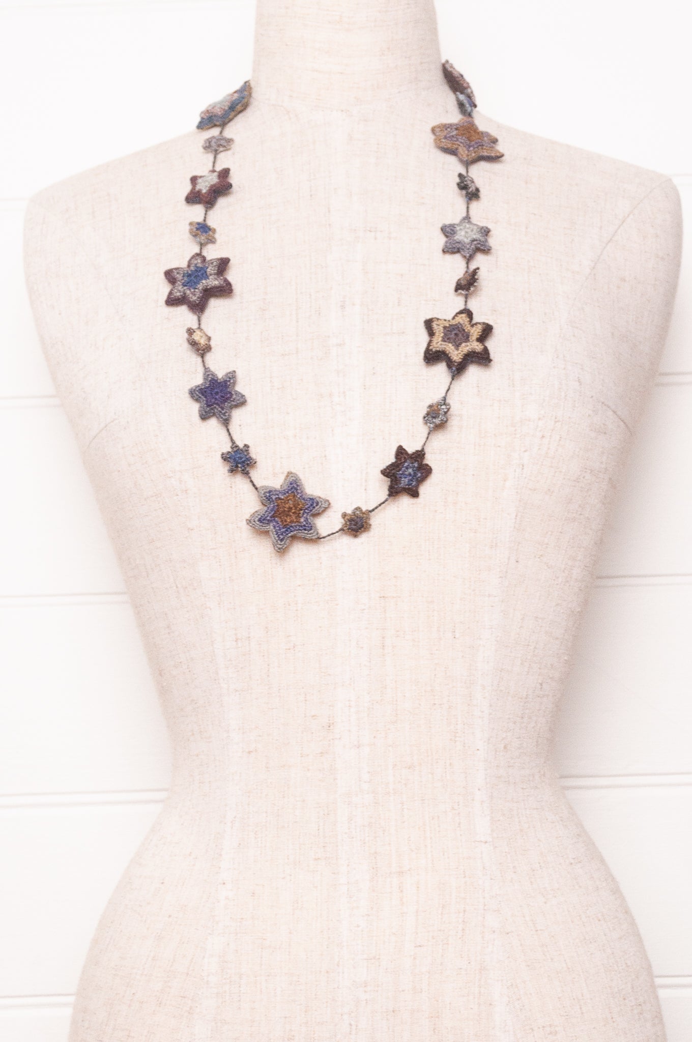 Sophie Digard etoile star crocheted linen necklace in deep shades of navy and browns.