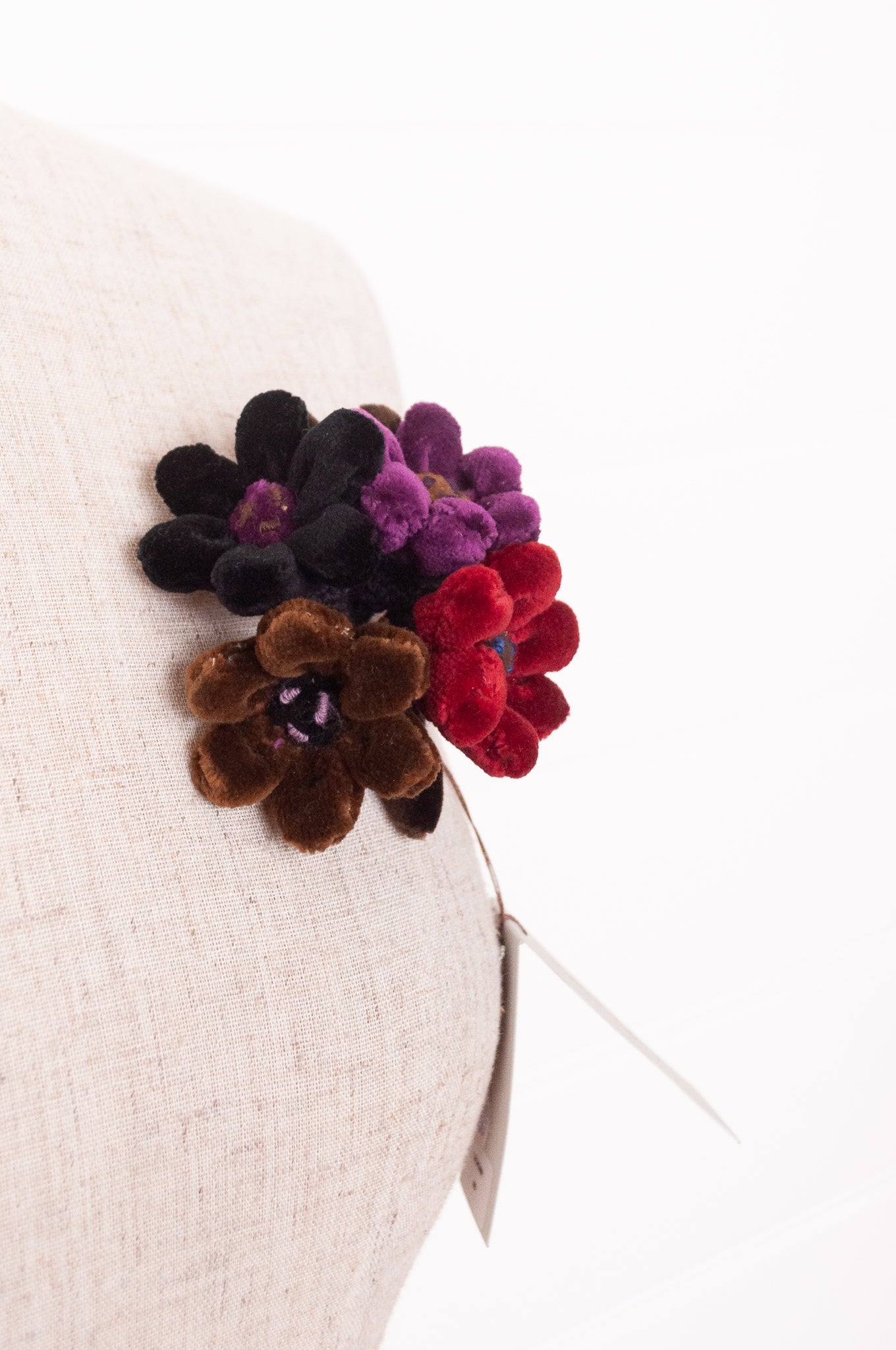 Sophie Digard velour flower jonquille brooch in deep wintery tones.