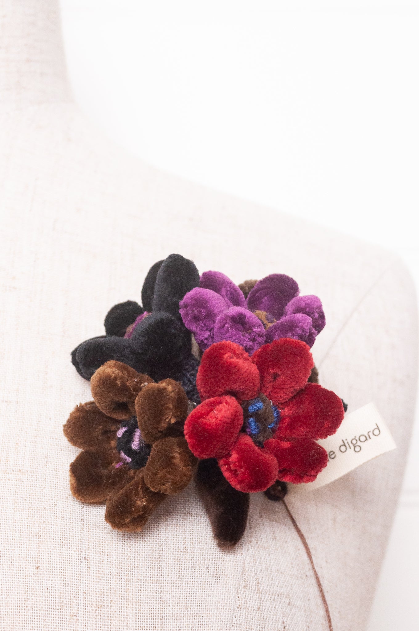 Sophie Digard velour flower jonquille brooch in deep wintery tones.