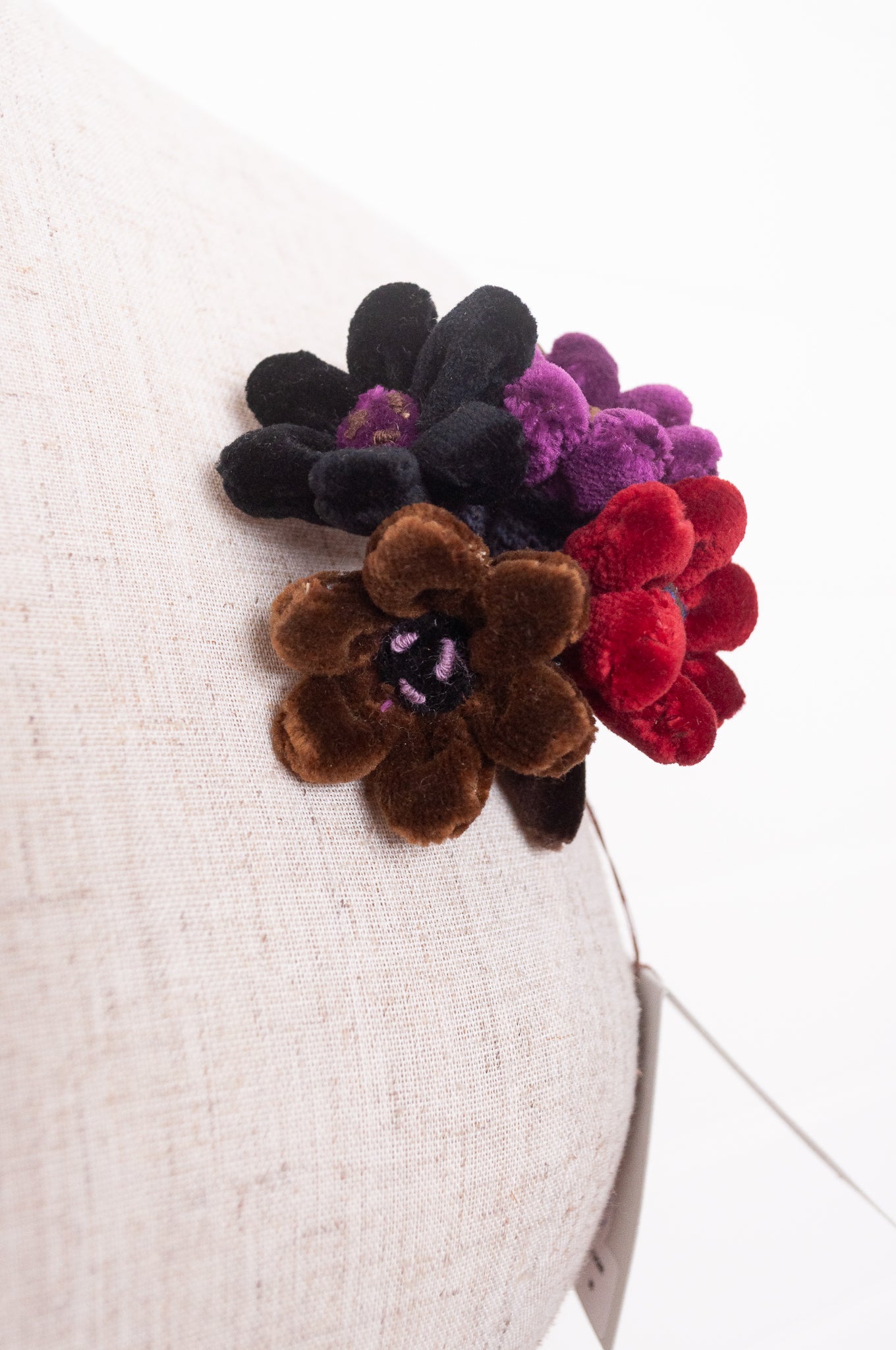 Sophie Digard velour flower jonquille brooch in deep wintery tones.