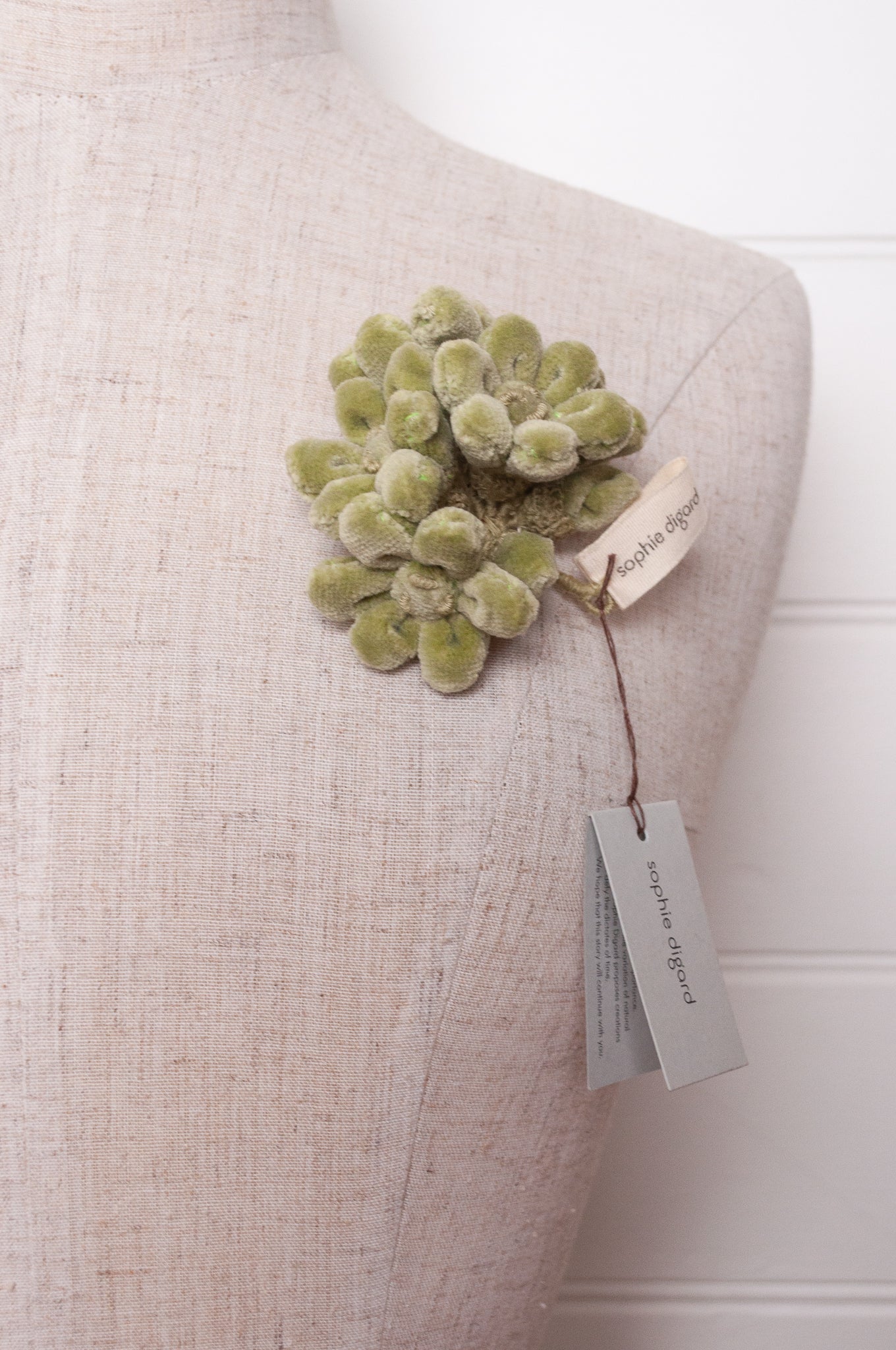 Sophie Digard velour flower jonquille brooch in soft sage green.