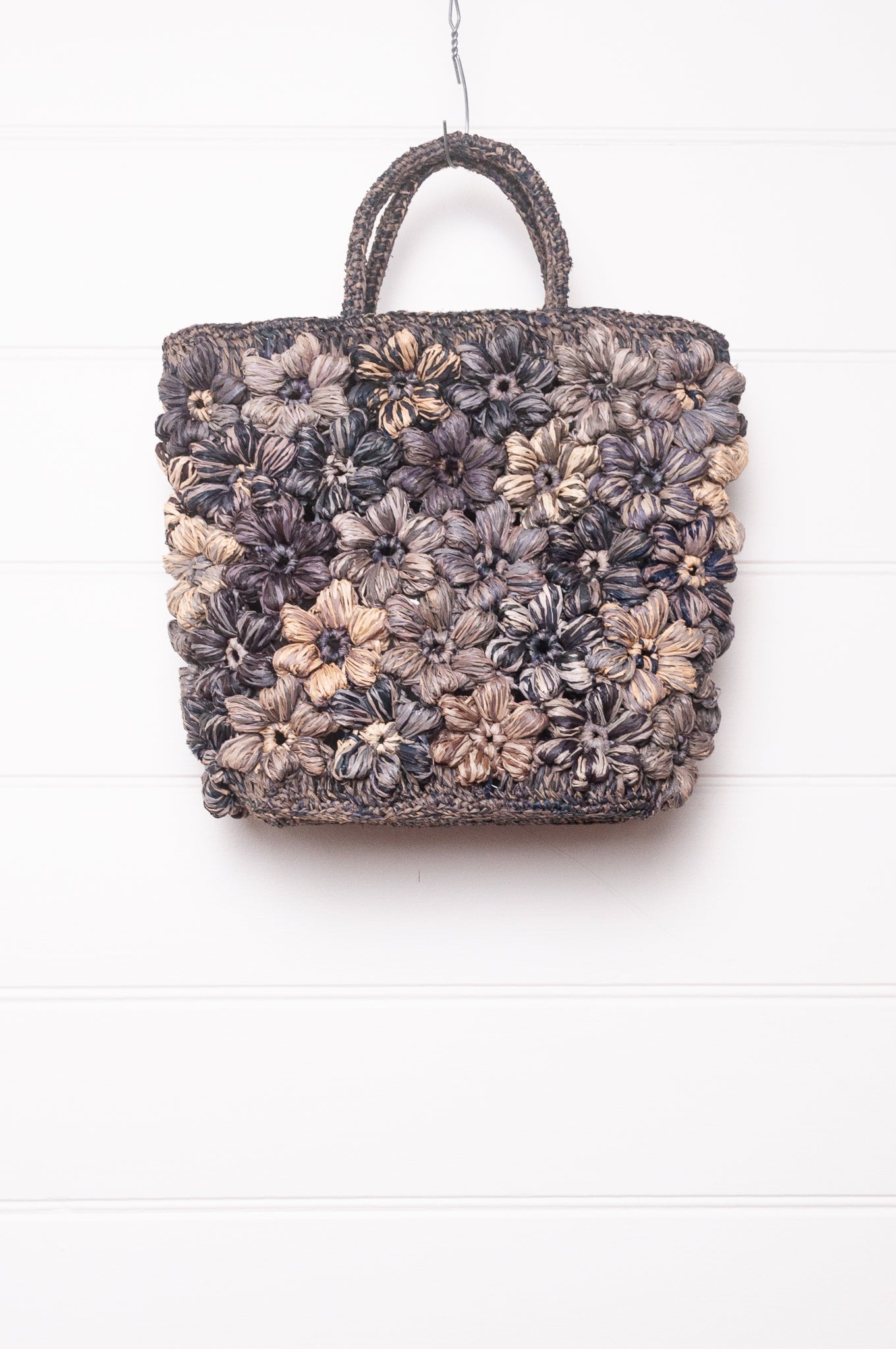 Sophie Digard croceht raffia bag with flowers in shades of blues and grey.