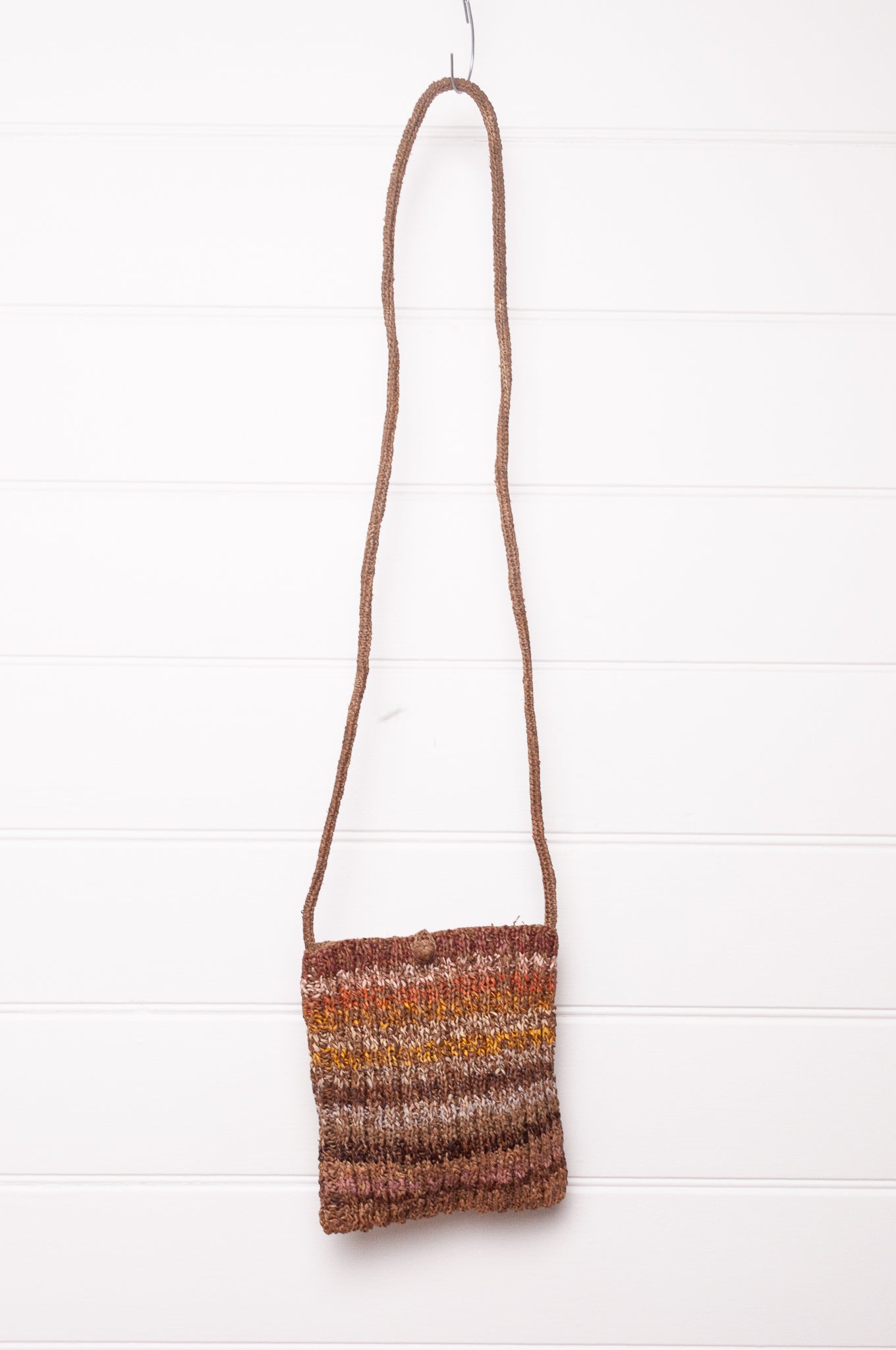 Sophie Digard small knitted raffia cross body bag in stripes of natural earthy tones.