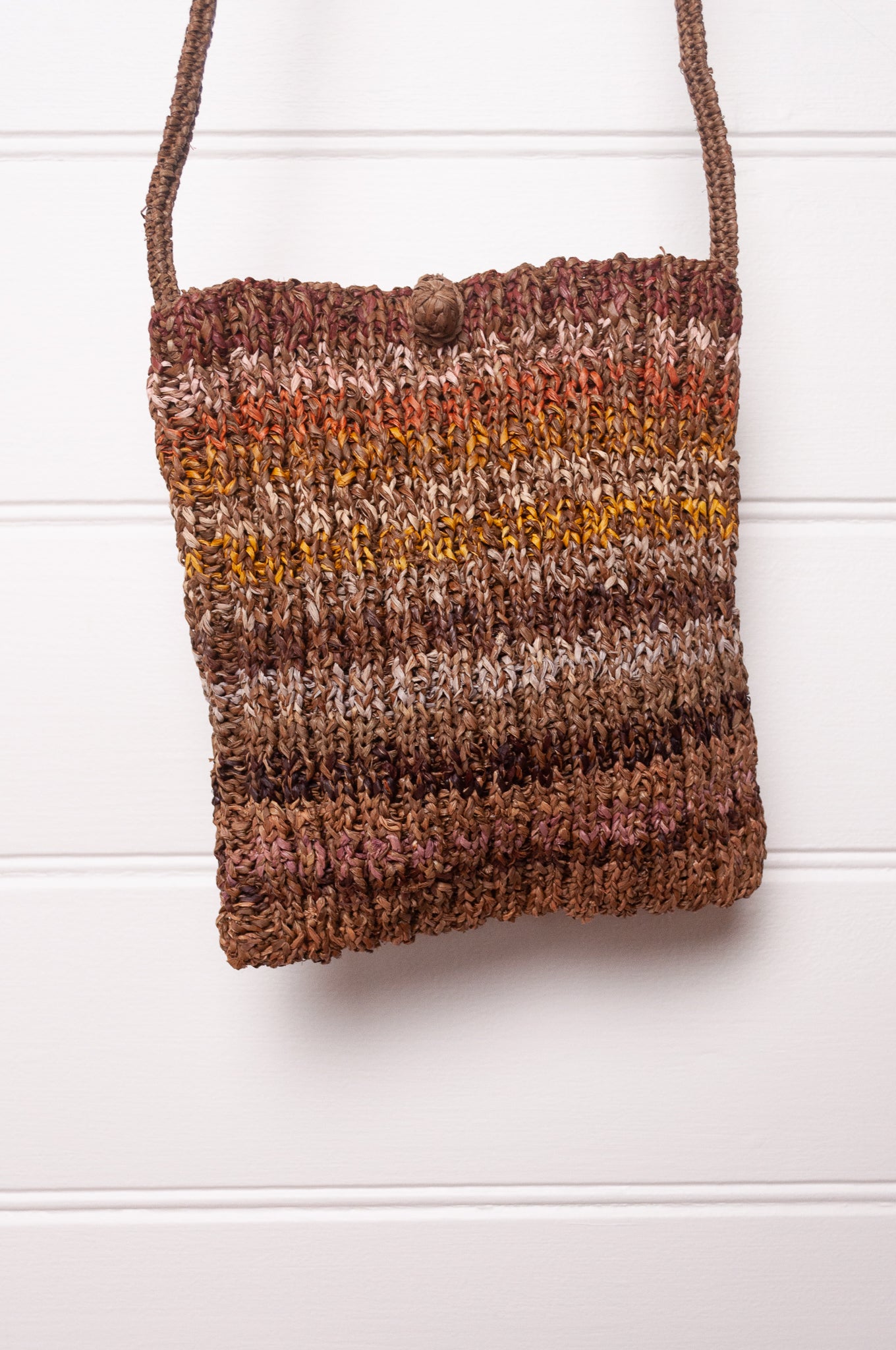 Sophie Digard small knitted raffia cross body bag in stripes of natural earthy tones.