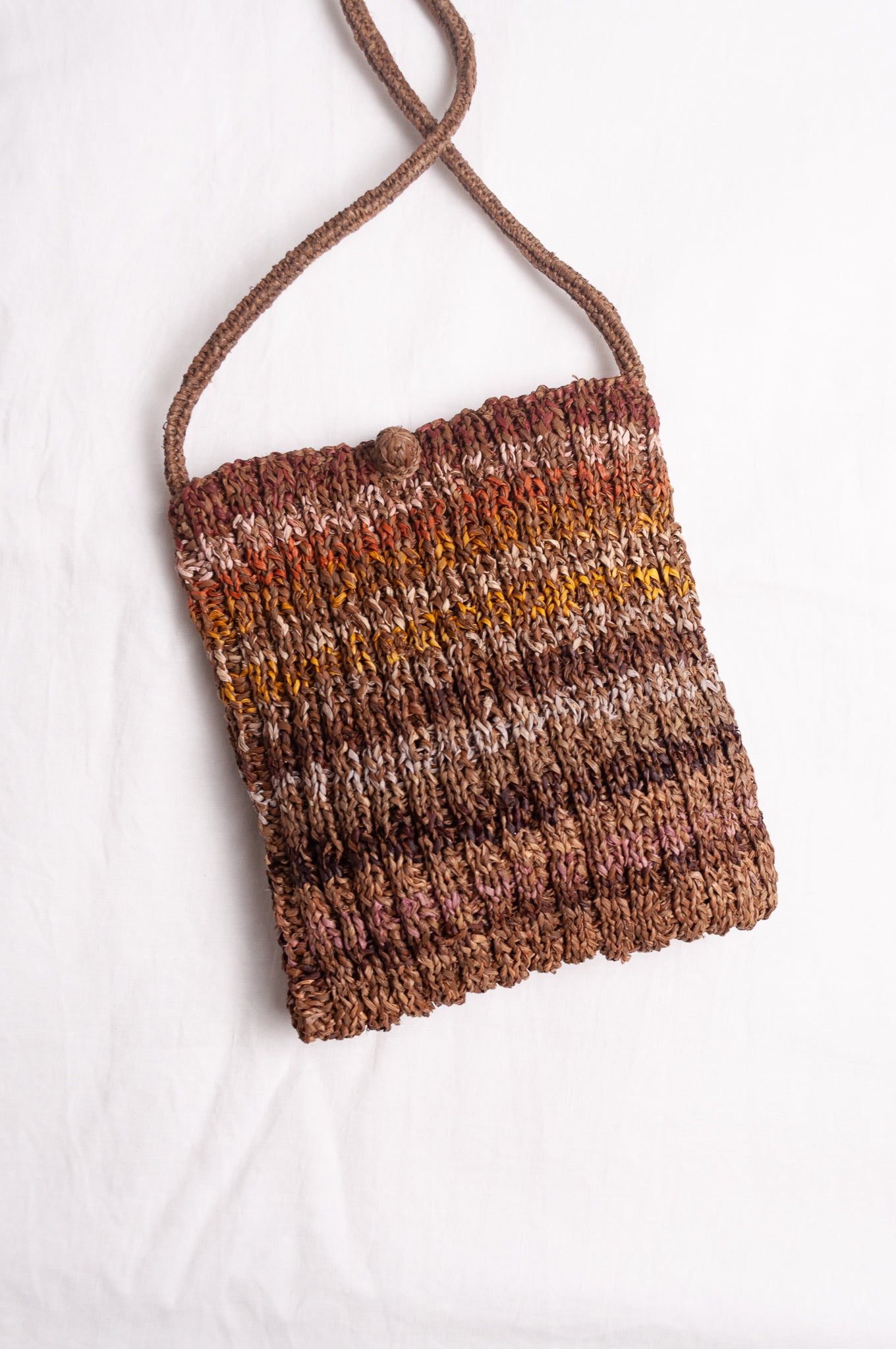Sophie Digard small knitted raffia cross body bag in stripes of natural earthy tones.