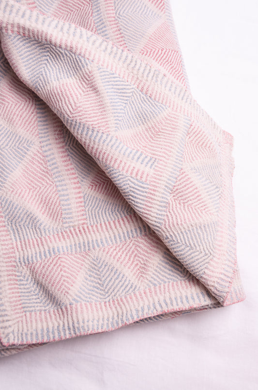 Vintage pink and blue on white lohori kantha quilt.