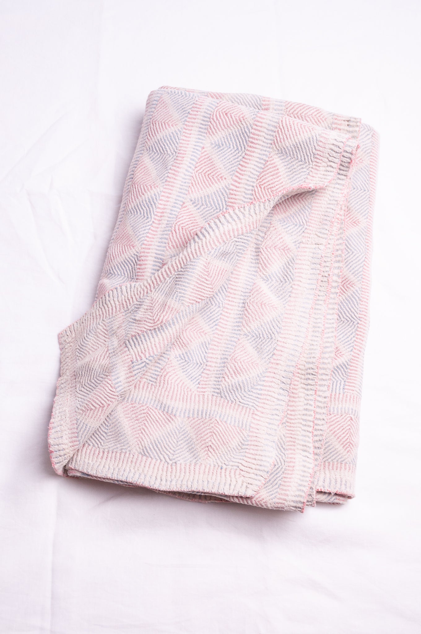 Vintage pink and blue on white lohori kantha quilt.