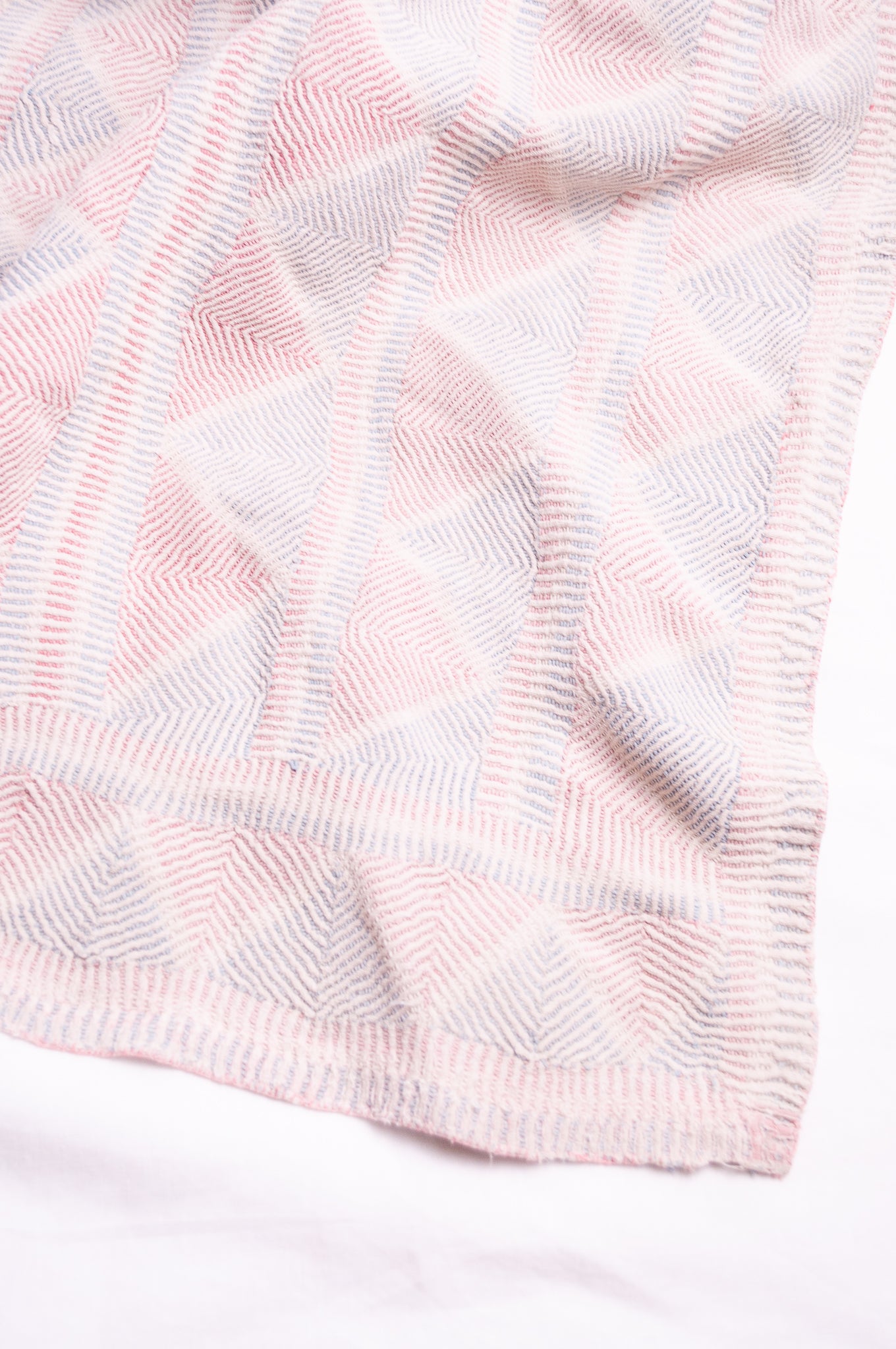 Vintage pink and blue on white lohori kantha quilt.
