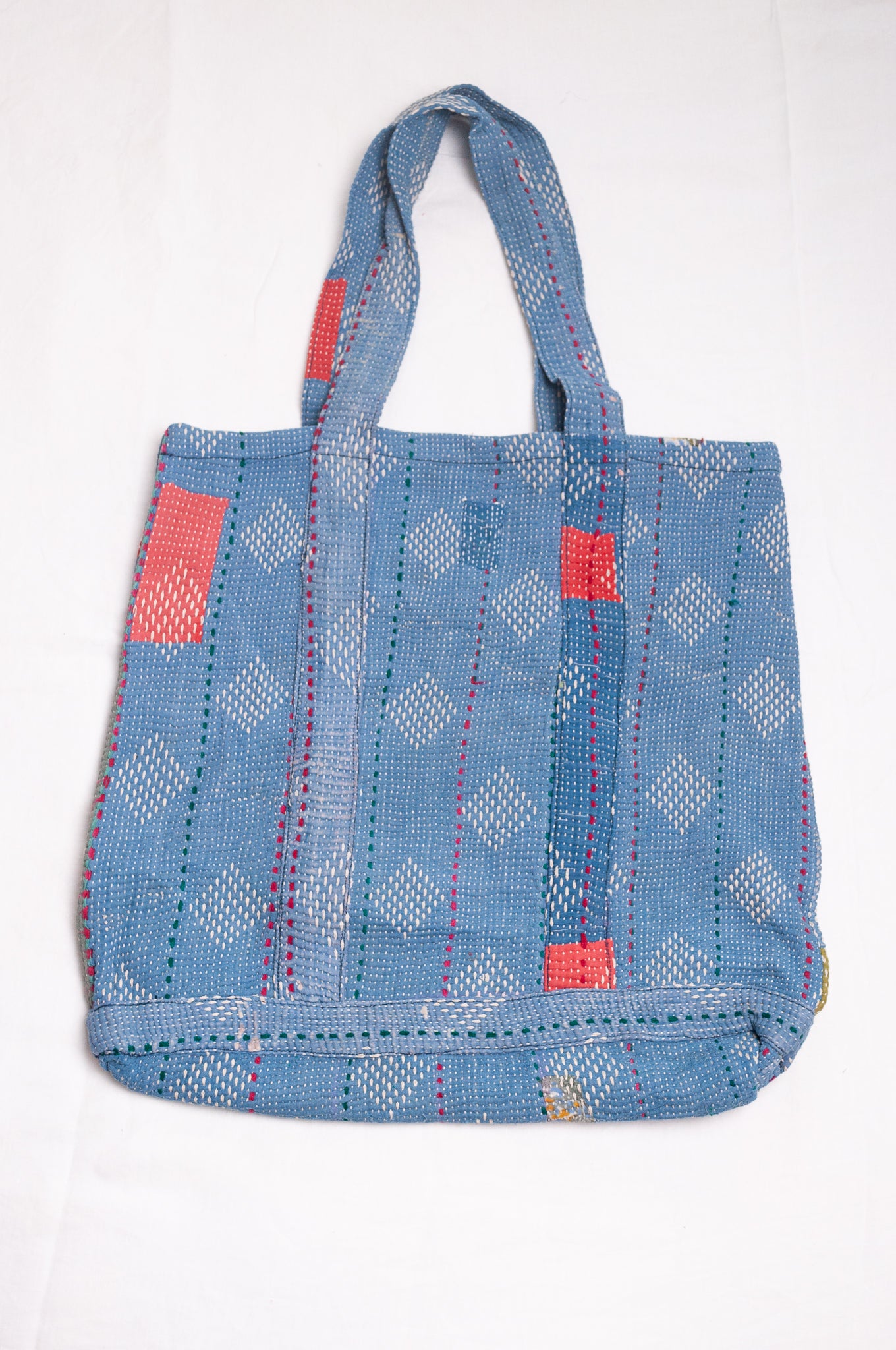 Vintage kantha quilt tote bag in sky blue with white embroidery.