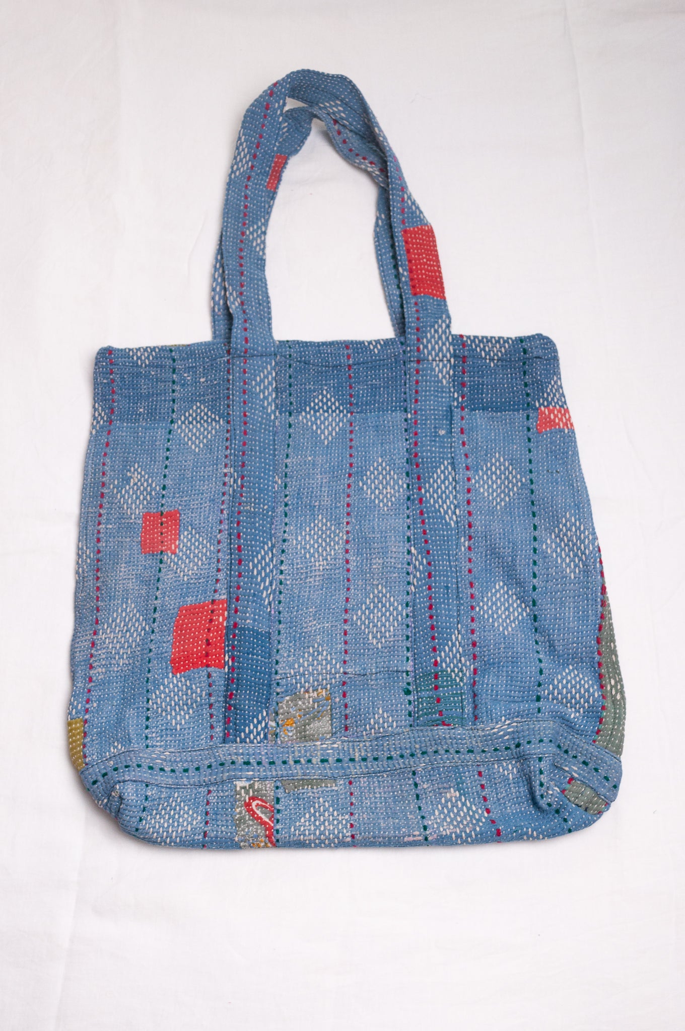 Vintage kantha quilt tote bag in sky blue with white embroidery.