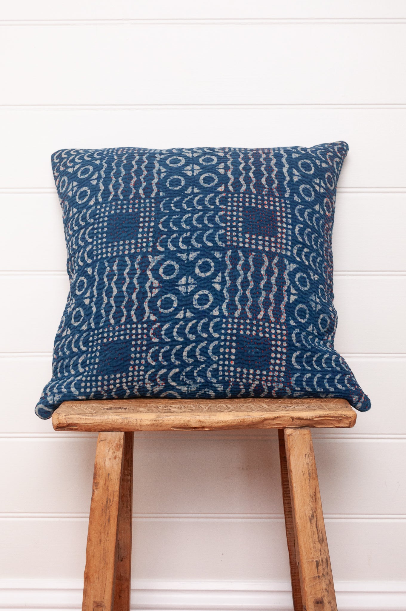 Vintage indigo kantha cushion overdyed with patchwork print.