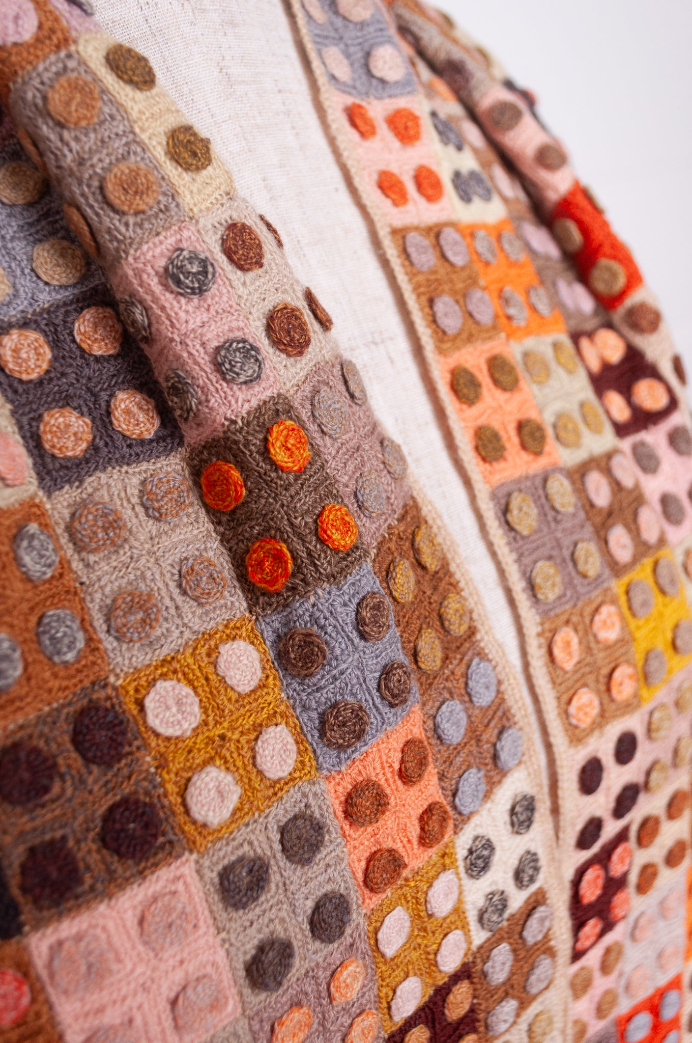 Sophie Digard crochet wool scarf tiny squares with spots in warm earthy tones.