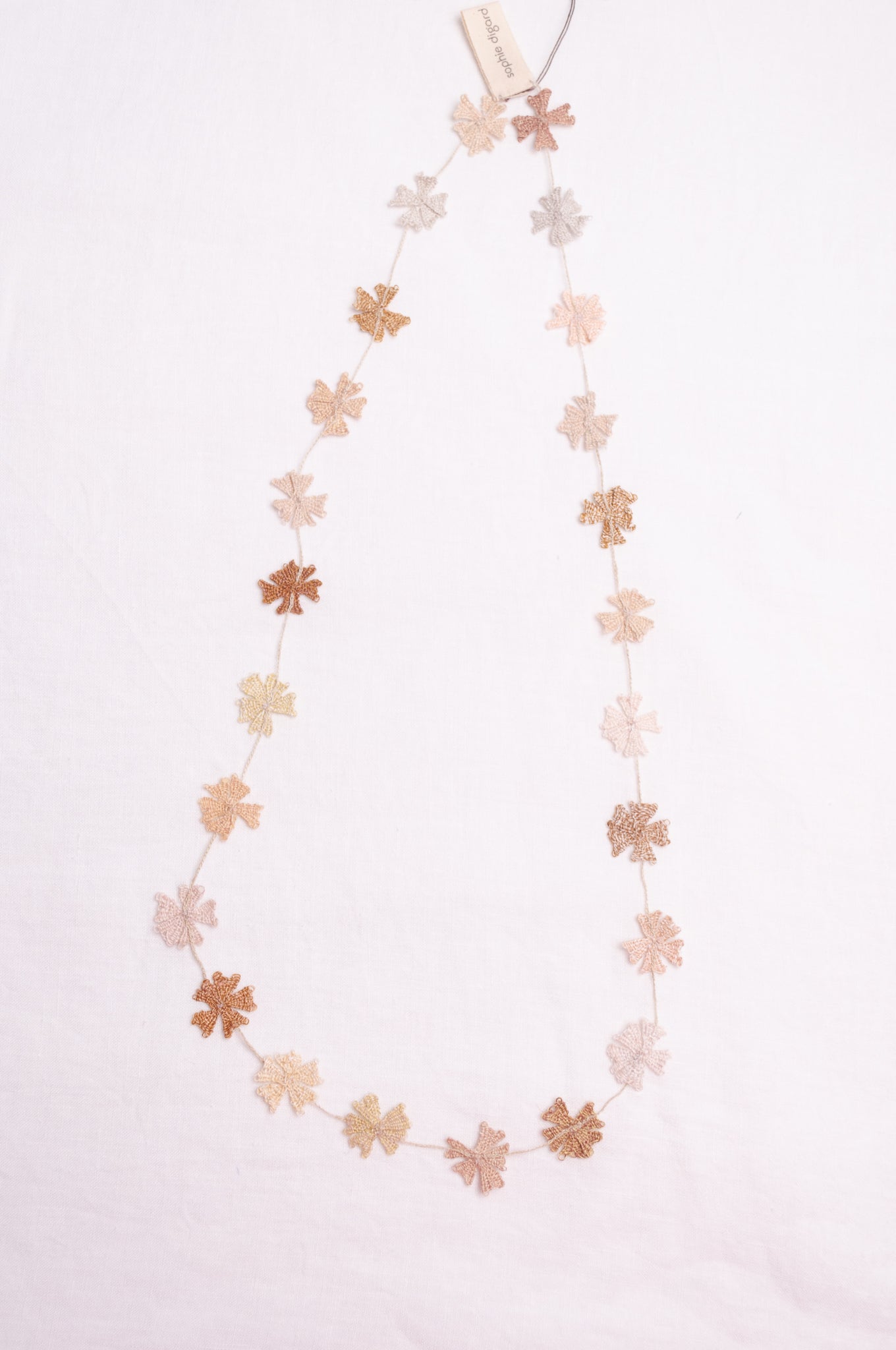 Sophie Digard fine crochet flower necklace in natural tones.