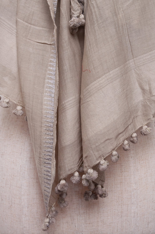 Silk and cotton scarf with pom poms in mist grey.