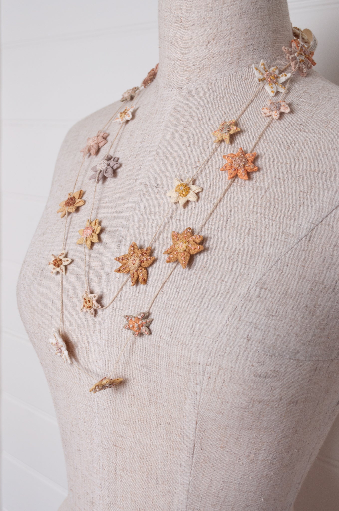 Sophie Digard star flower embroidered linen necklace in warm neutrals.
