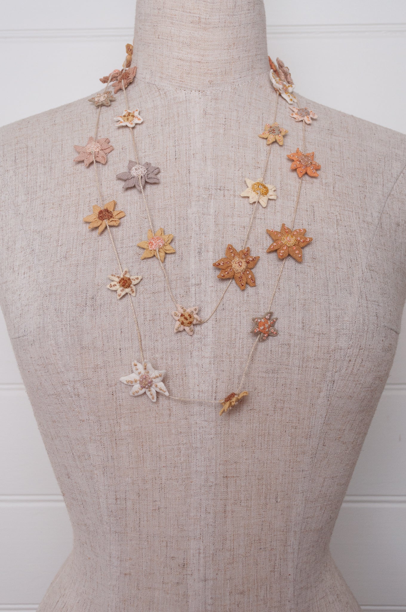 Sophie Digard star flower embroidered linen necklace in warm neutrals.