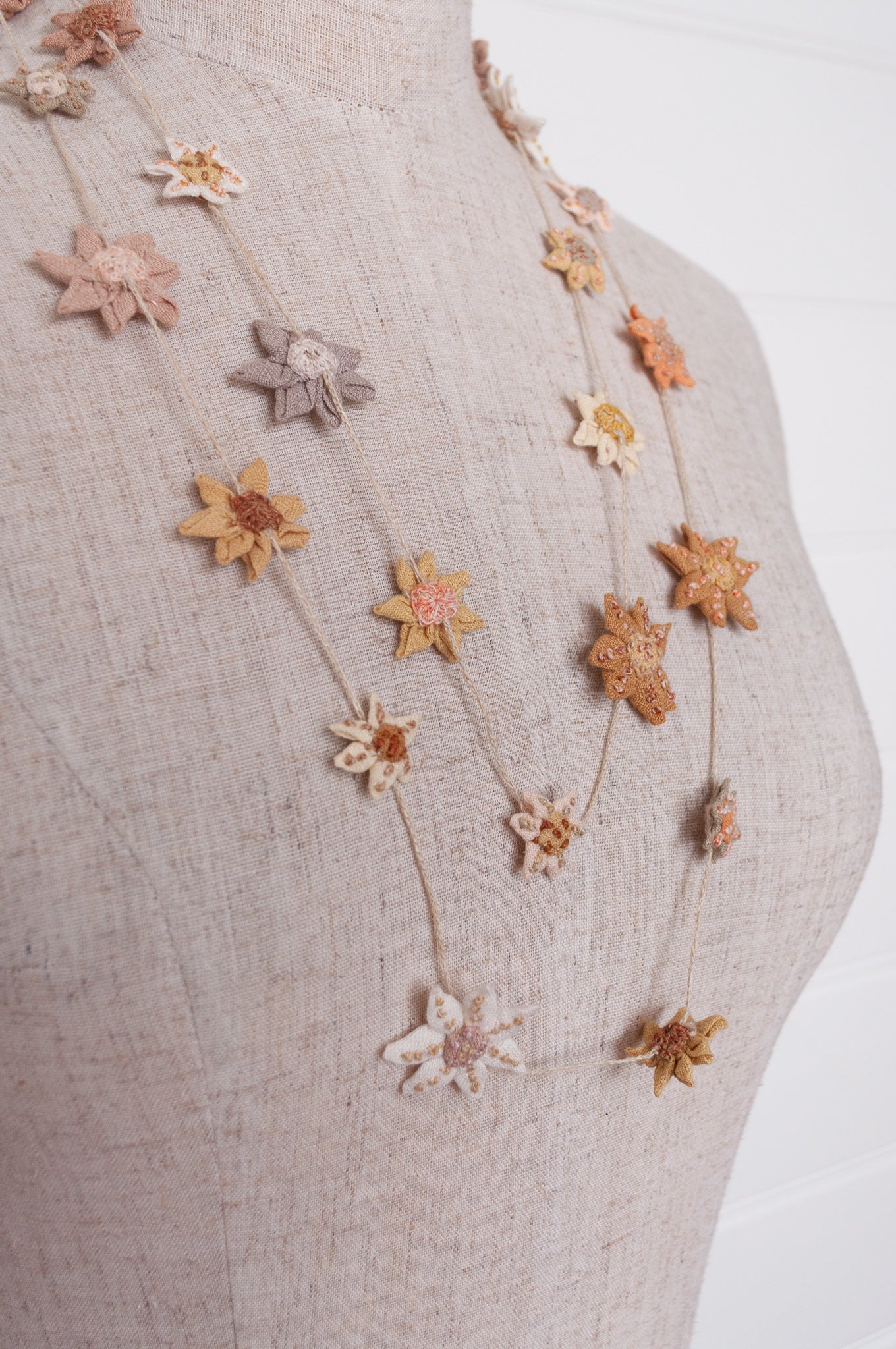 Sophie Digard star flower embroidered linen necklace in warm neutrals.