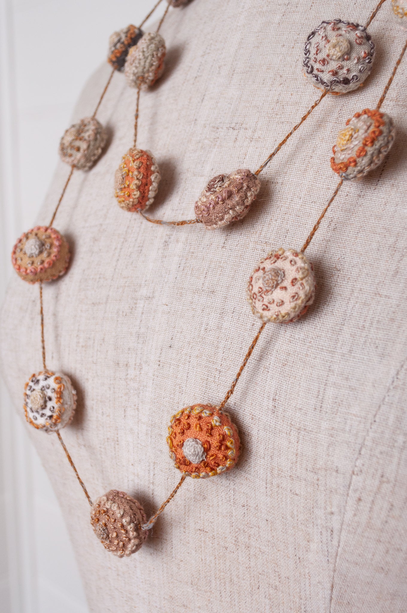 Sophie Digard embroidered linen medallions necklace in warm neutrals.